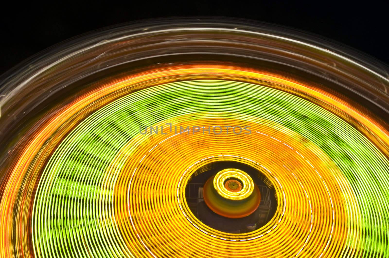 motion blur of a colorful ferris wheel at night