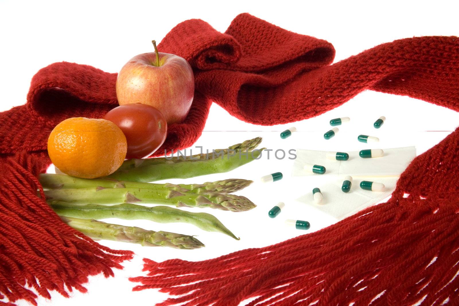 A scarf wrapped around fruits, vegetables, medicaments, handkerchiefs representing health care.