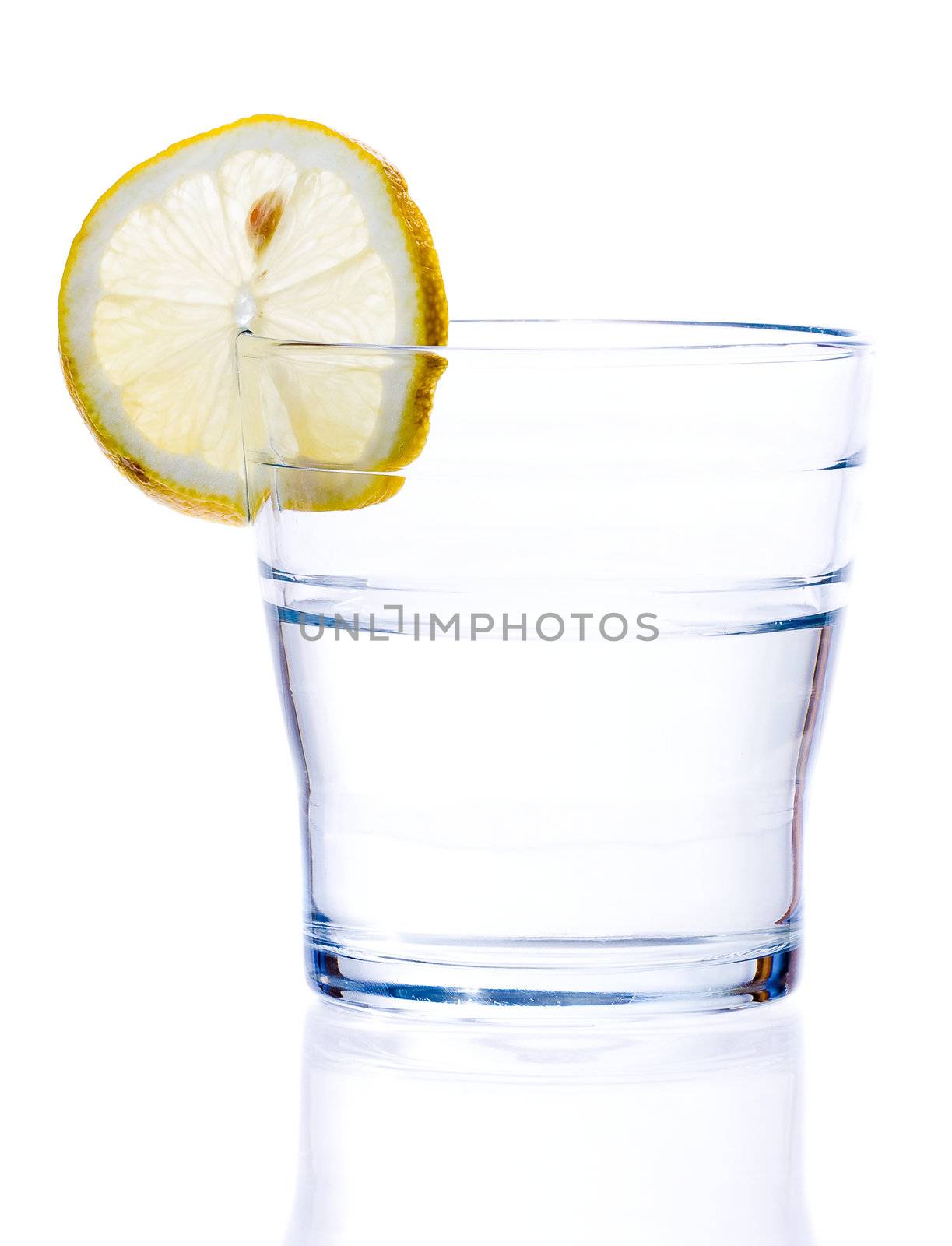 glass of liquid with lemon isolated over a withe background