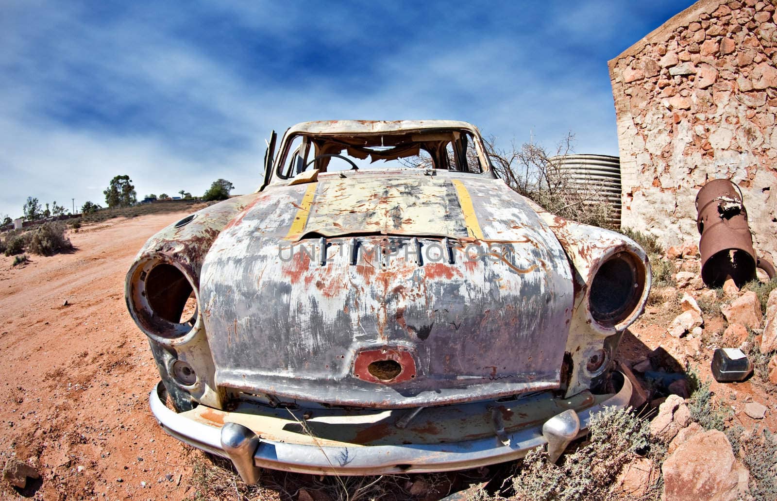 great image of an old car rusting away in the desert