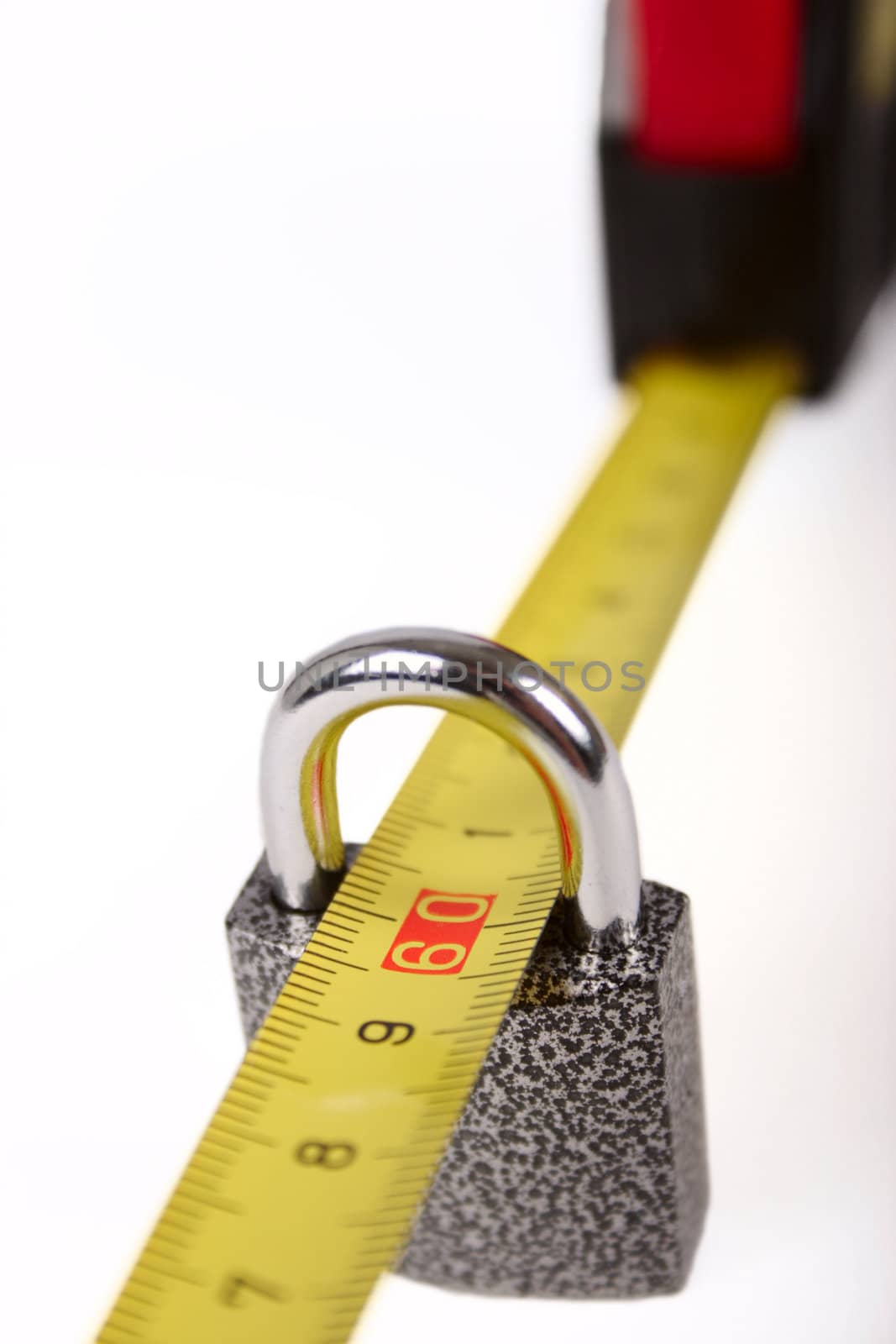Yellow measuring tape passed through the closed lock removed close up