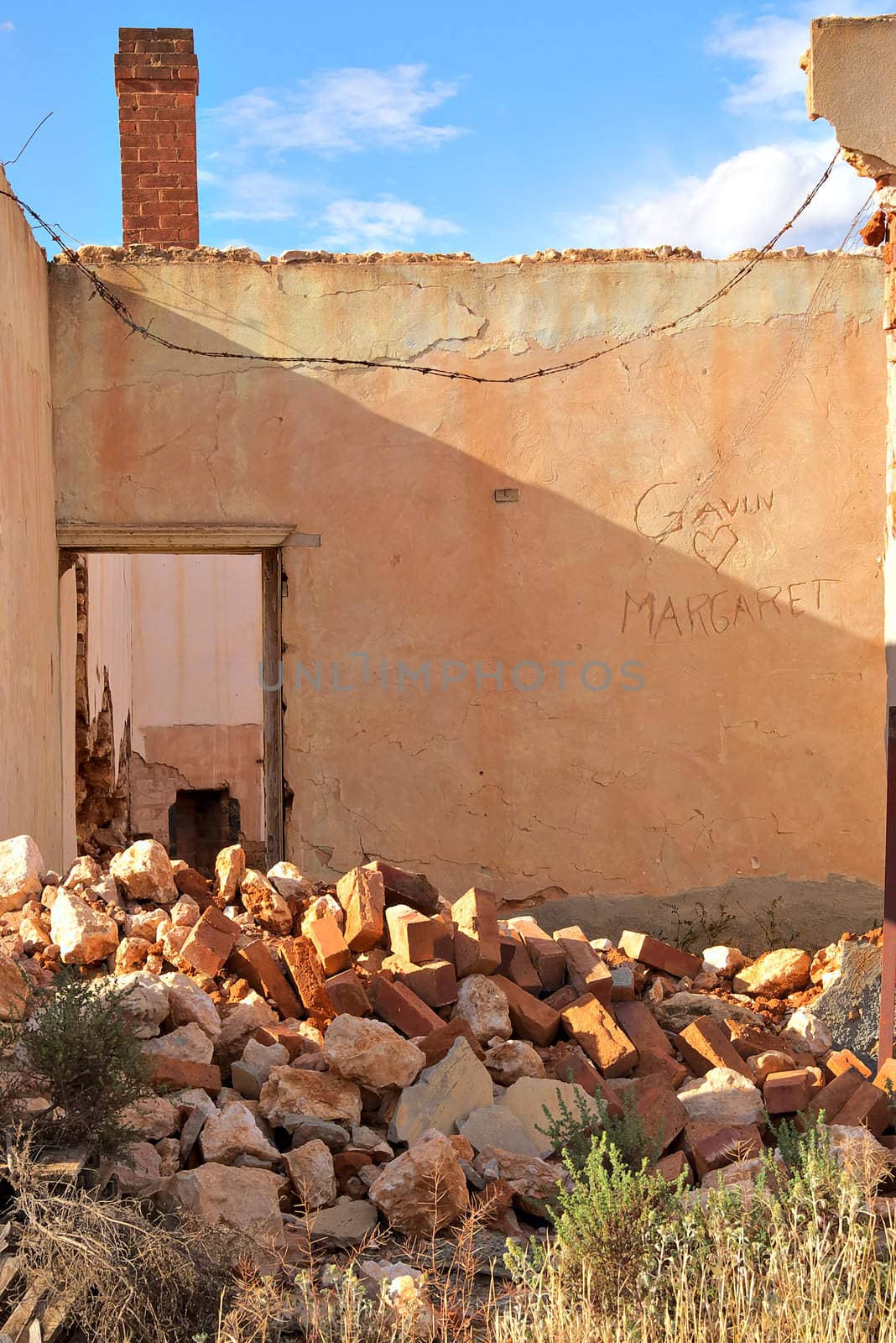 an old farm house lays in ruins and falling apart