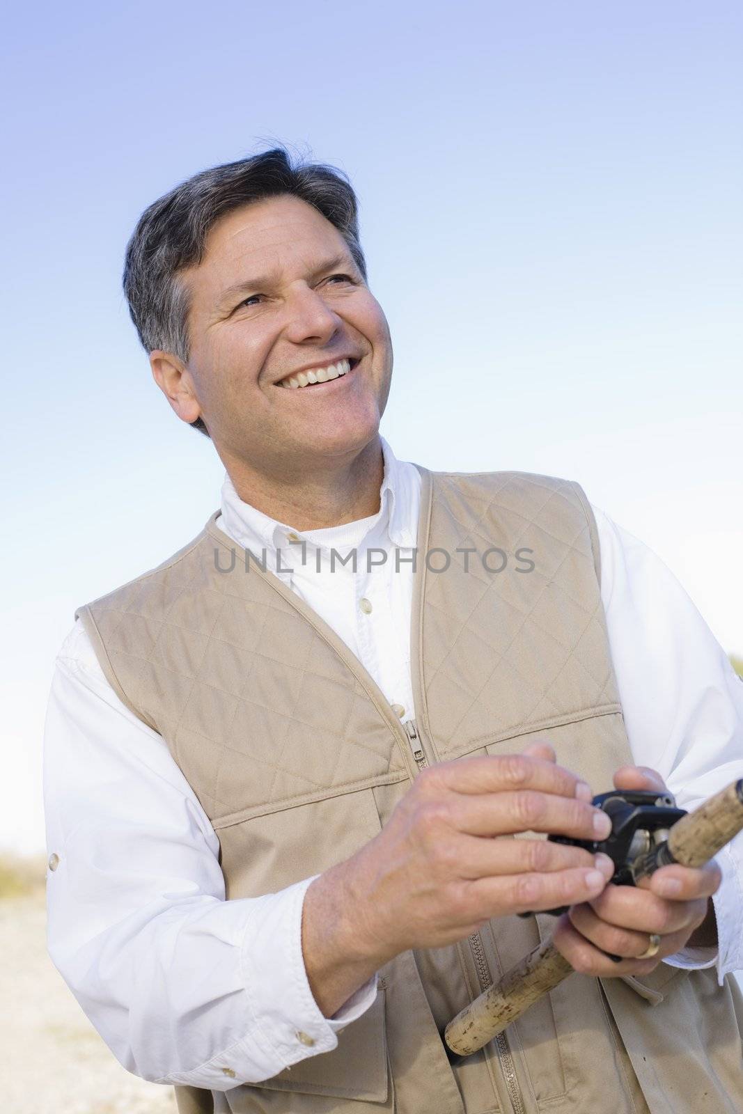 Man Standing By A River With A Fishing Pole