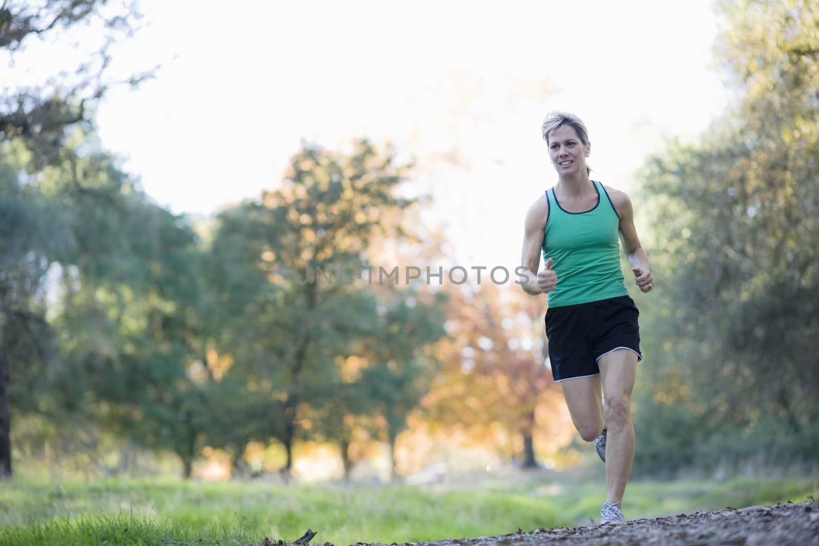 Pretty Athletic Woman Running in a Park