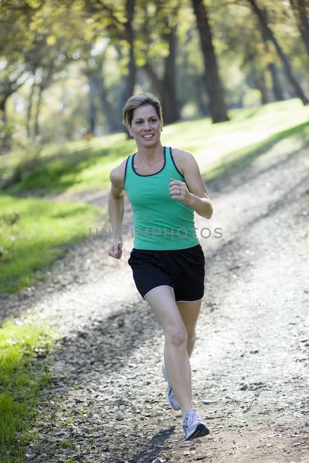 Pretty Athletic Woman Running in a Park