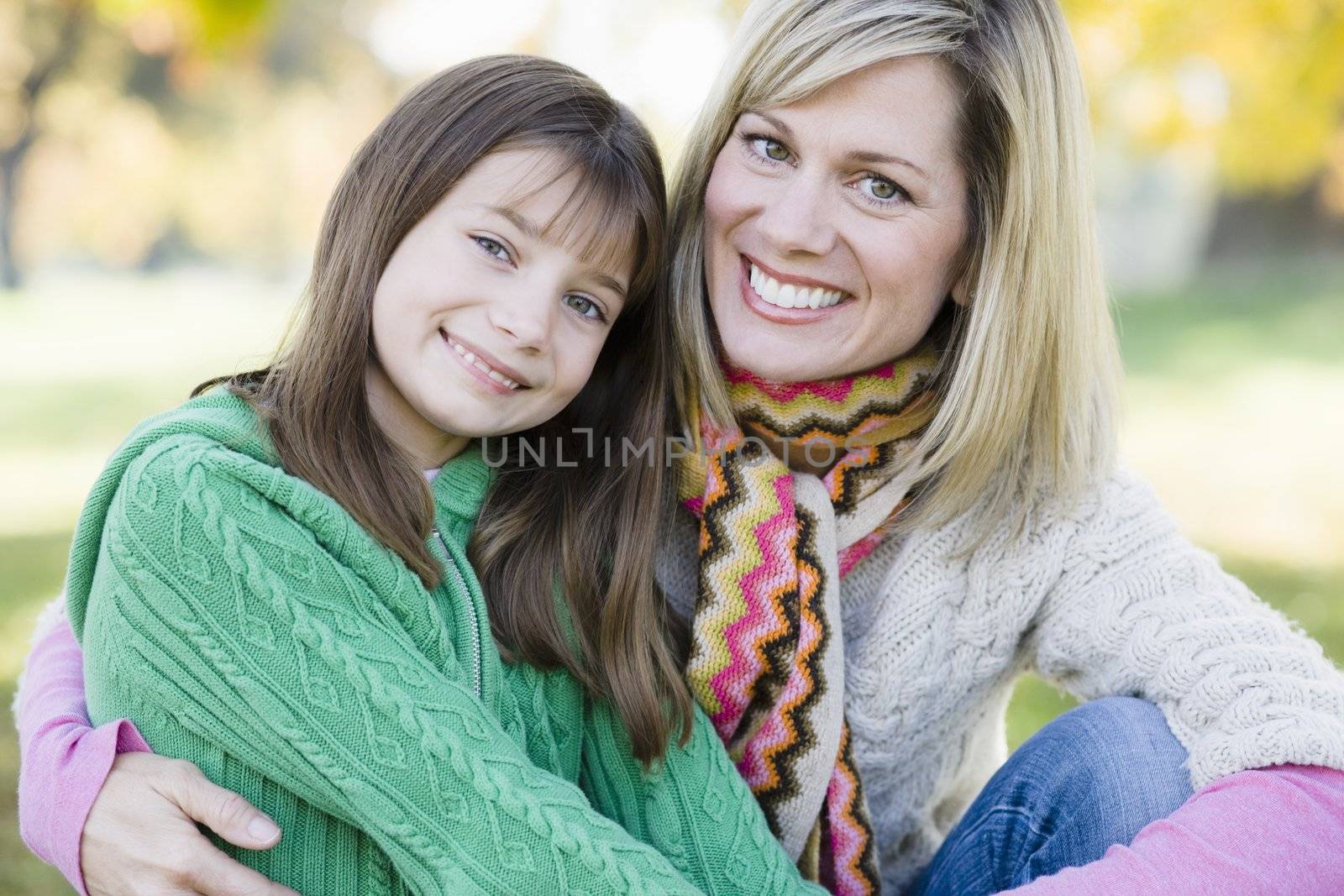 Portrait of a Mother and Daughter Sitting Together in a Park