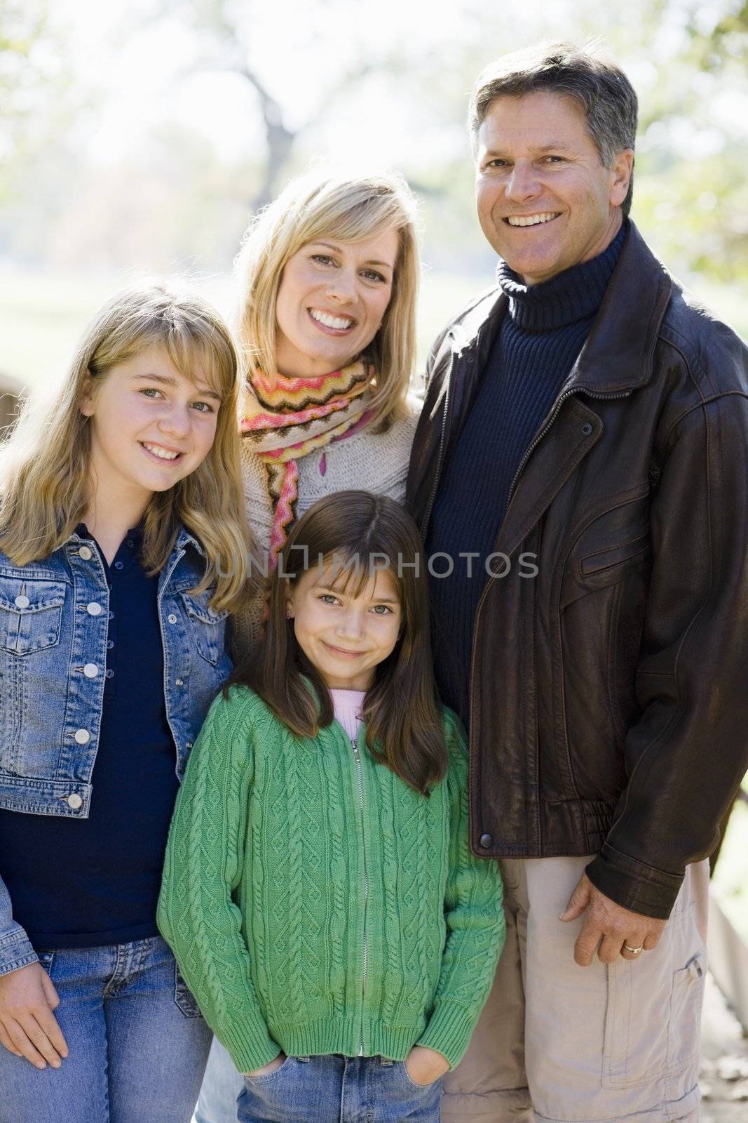 Outdoor Portrait of a Family of Four Standing in a Park
