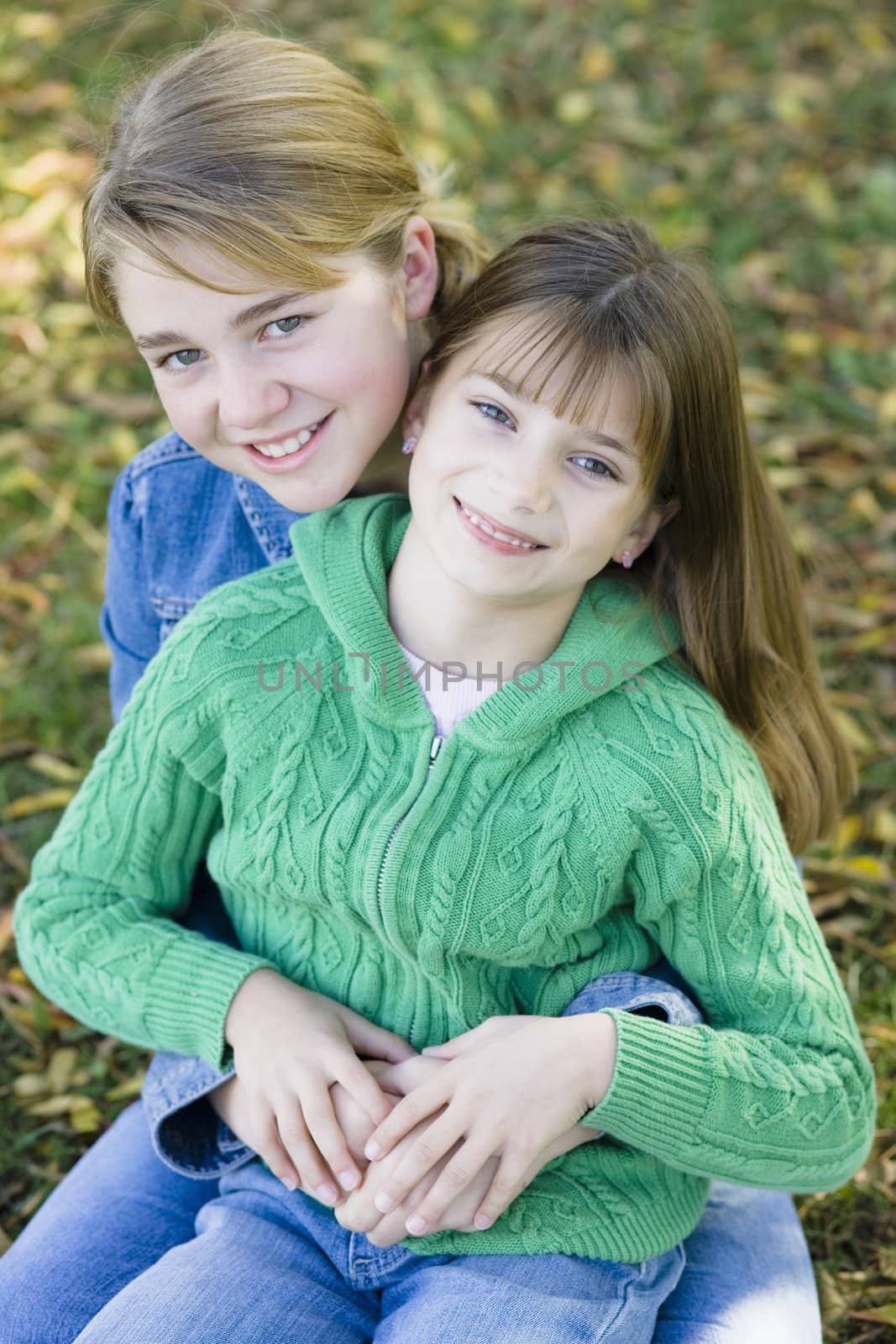 Portrait of Two Sisters Holding Each Other in a Park