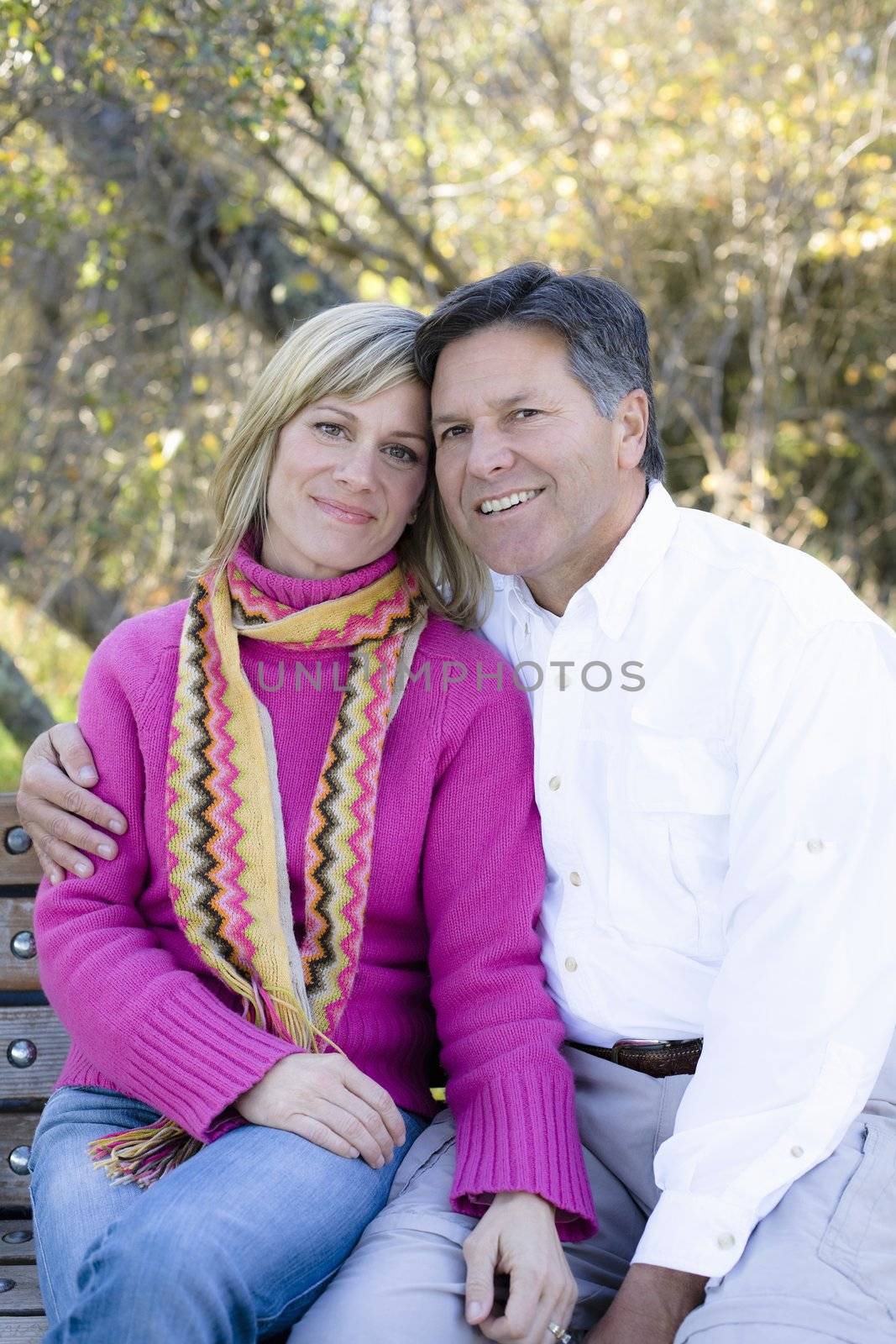 Portrait of a Smiling Married Couple Sitting on a Park Bench