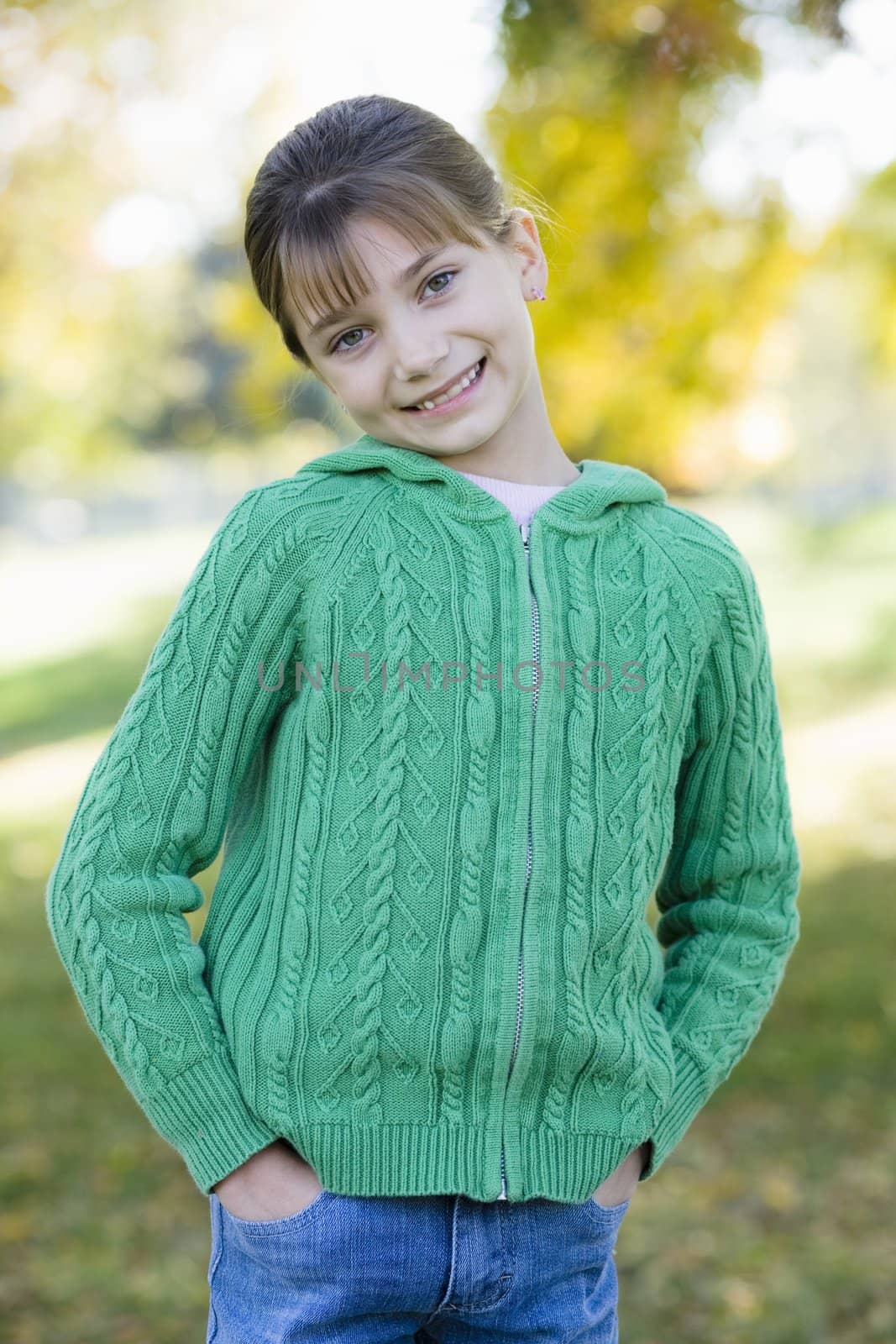 Portrait of a Cute Young Girl Standing in a Park