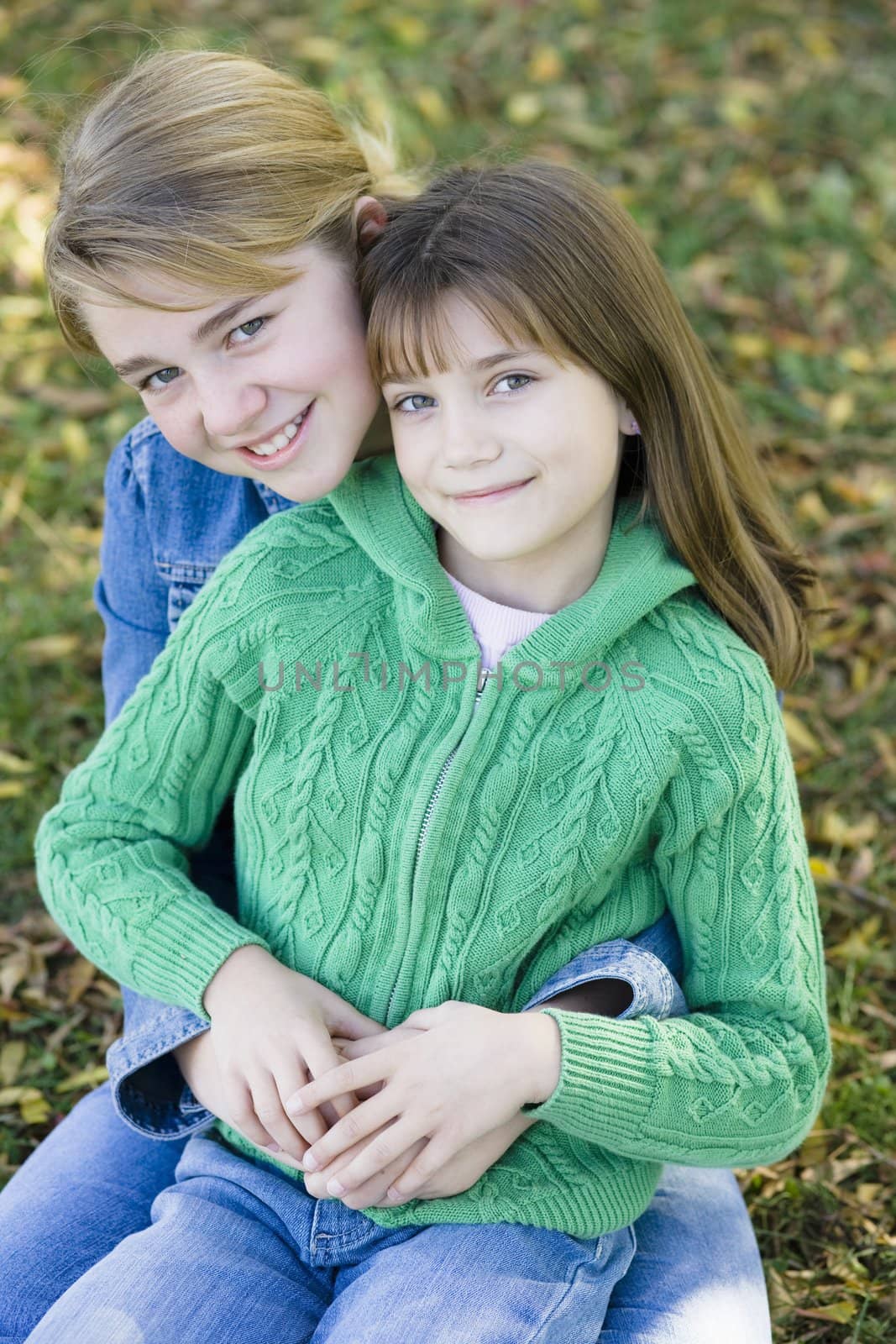 Portrait of Two Sisters Holding Each Other in a Park