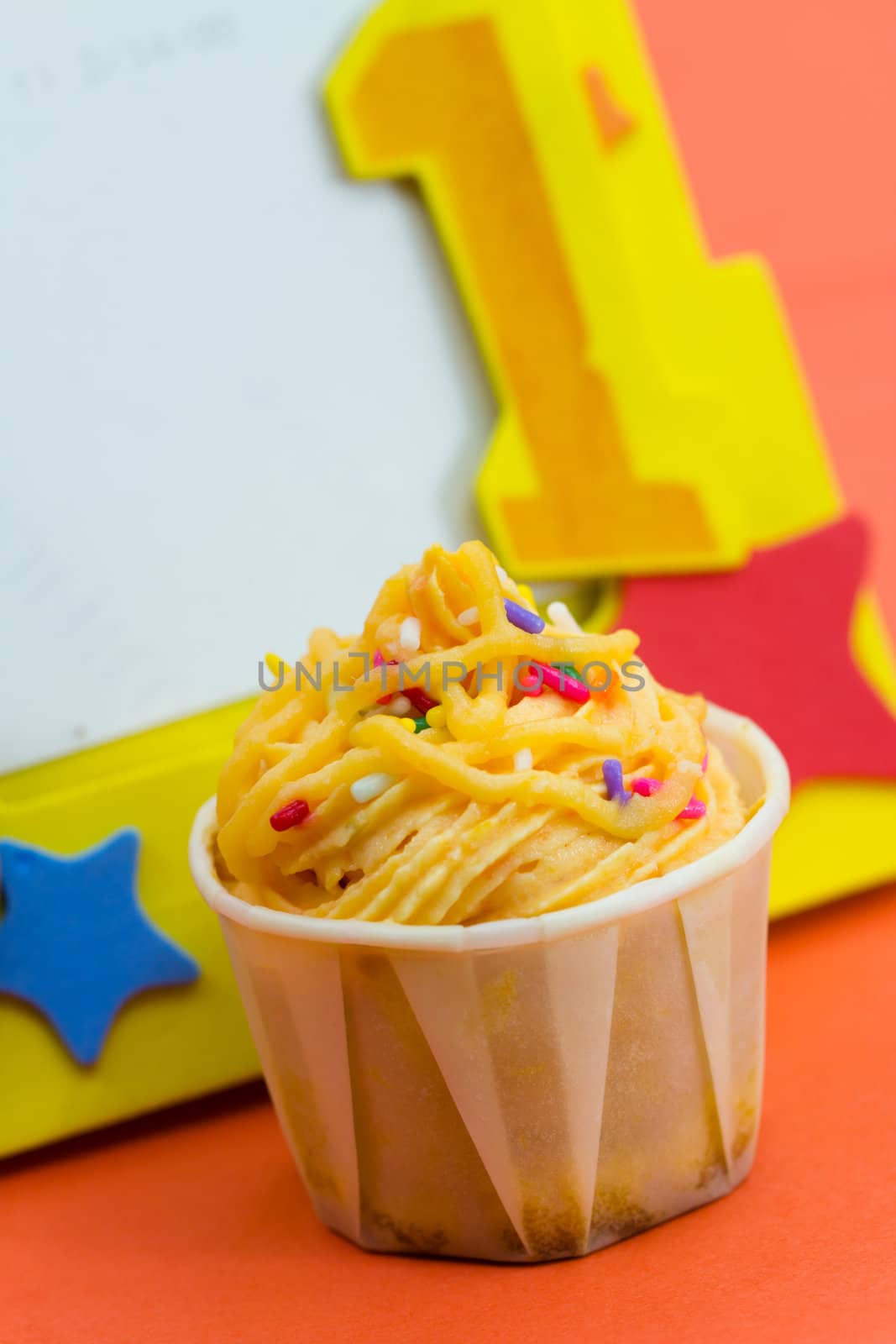 Cupcake decorated with yellow frosting and sugar