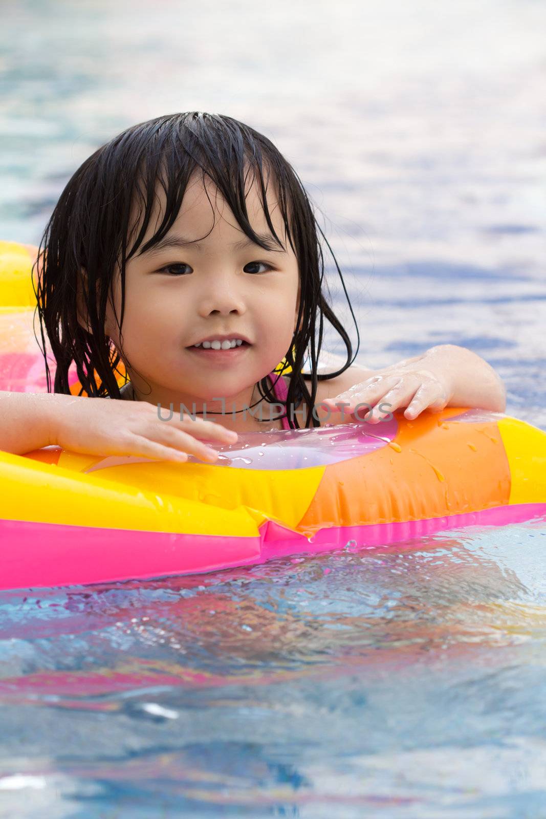 Little girl is having fun in swimming pool