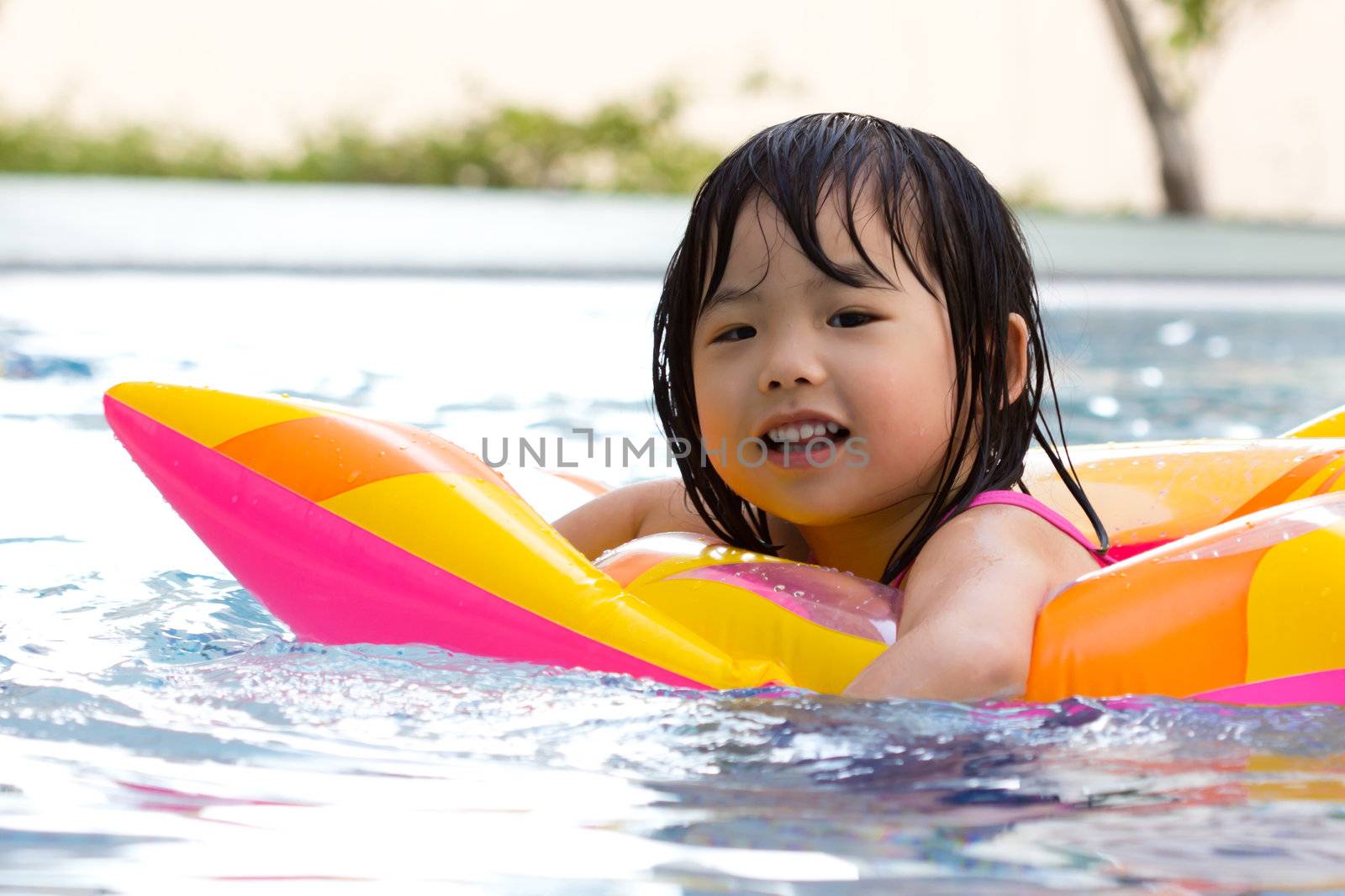 Little girl is having fun in swimming pool