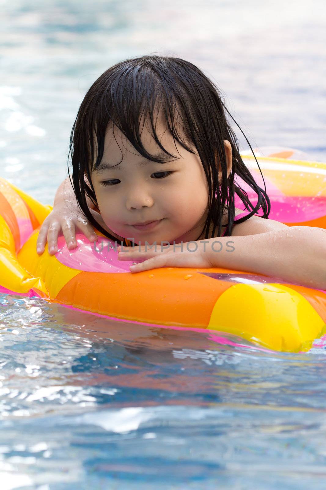 Little girl is having fun in swimming pool