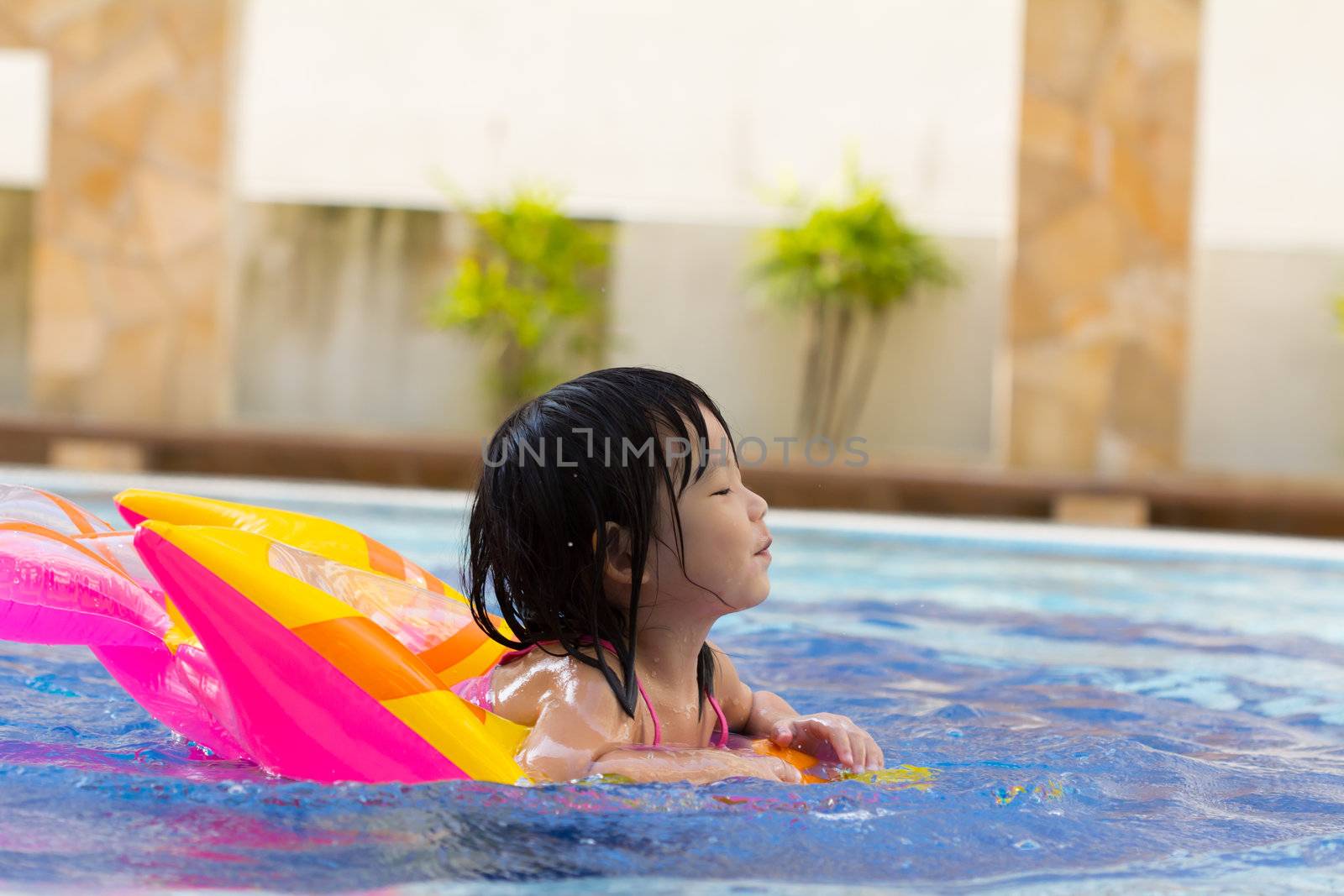 Little girl is having fun in swimming pool