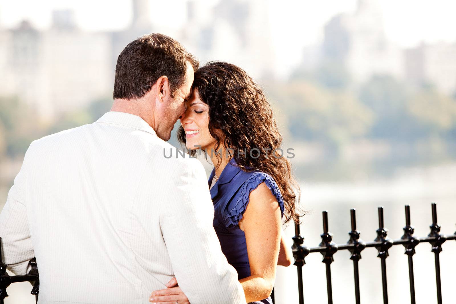 A man and woman in a park hugging