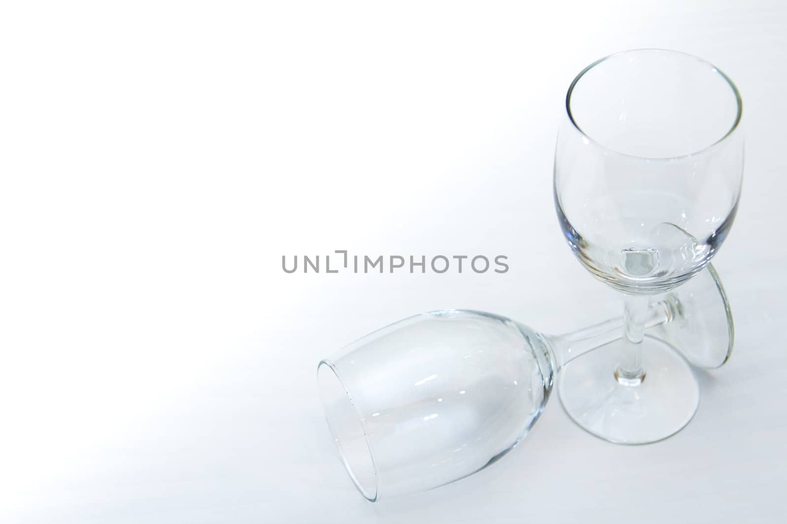 Two empty wine glasses isolated on a white background