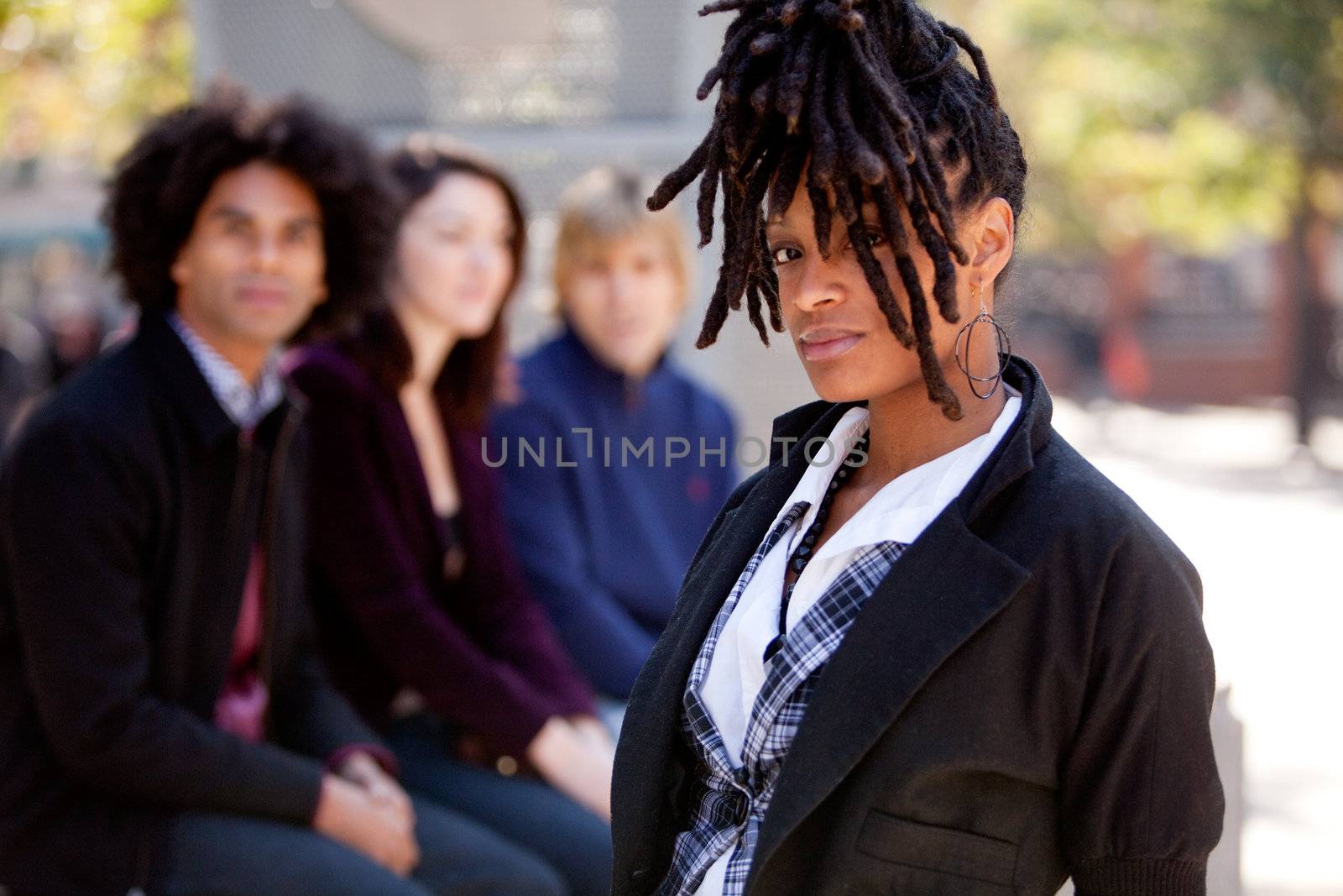 A group of young university students outdoors at school