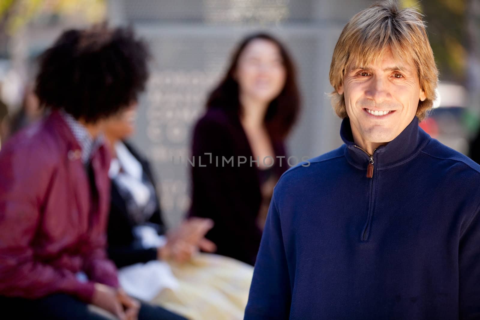 A portrait of a young man and a group of friends