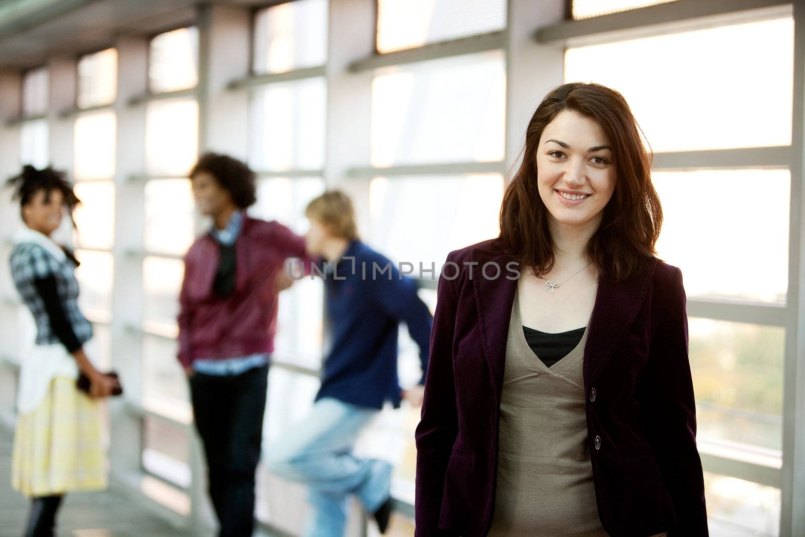 A portrait of a young woman with friends in the background
