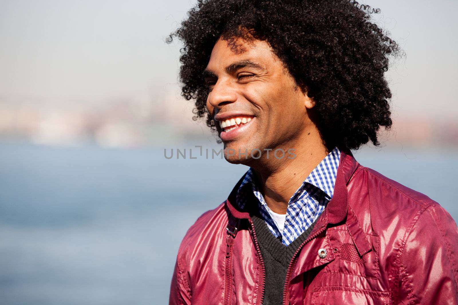 A portrait of a happy laughing African American man