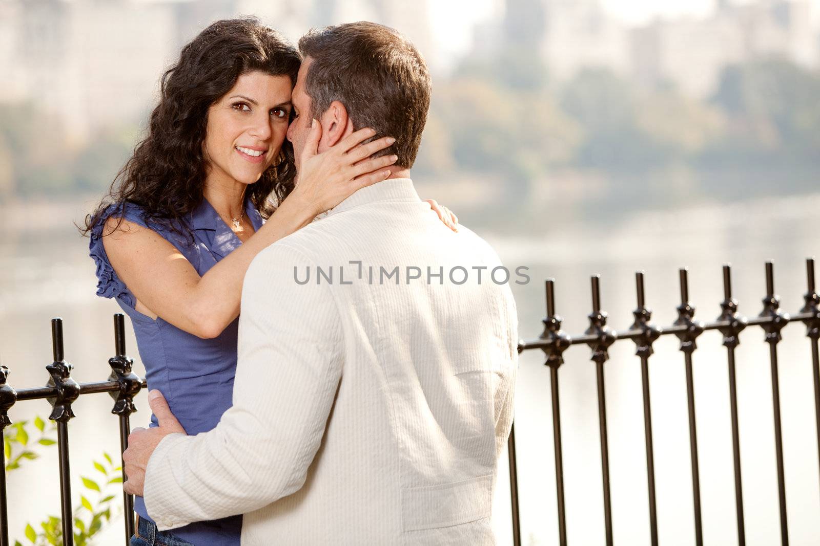 A couple hugging in the park - eye contact with the female