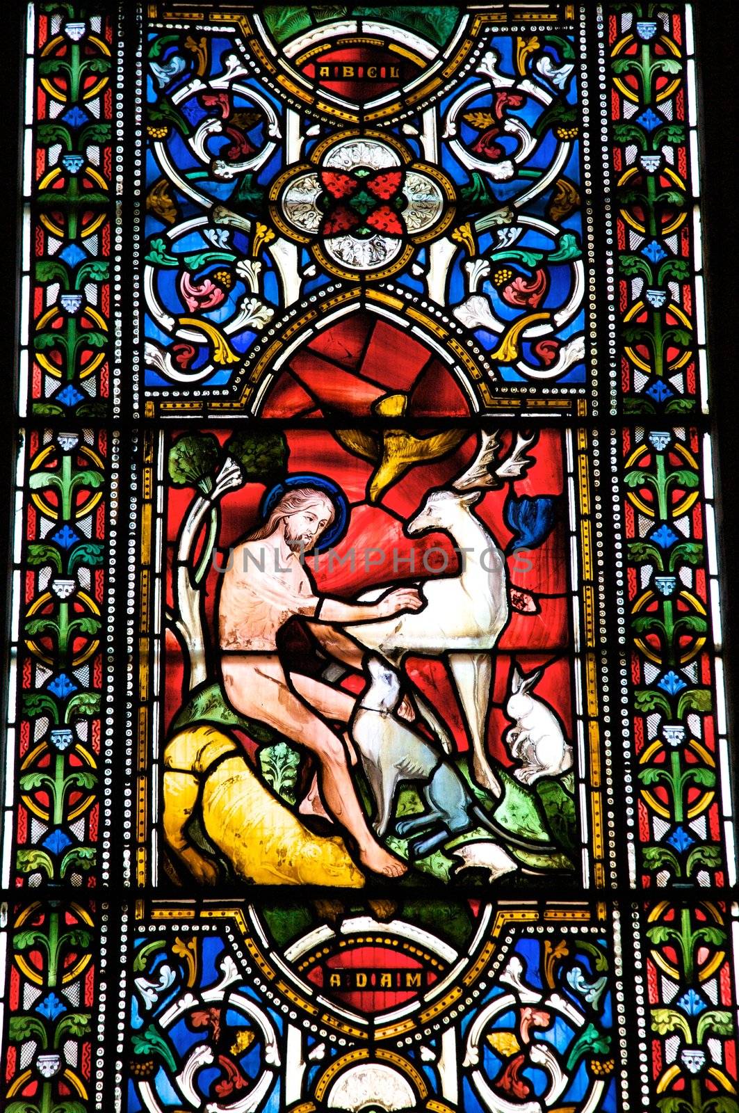 coloured glasswork painted nude christ and animals