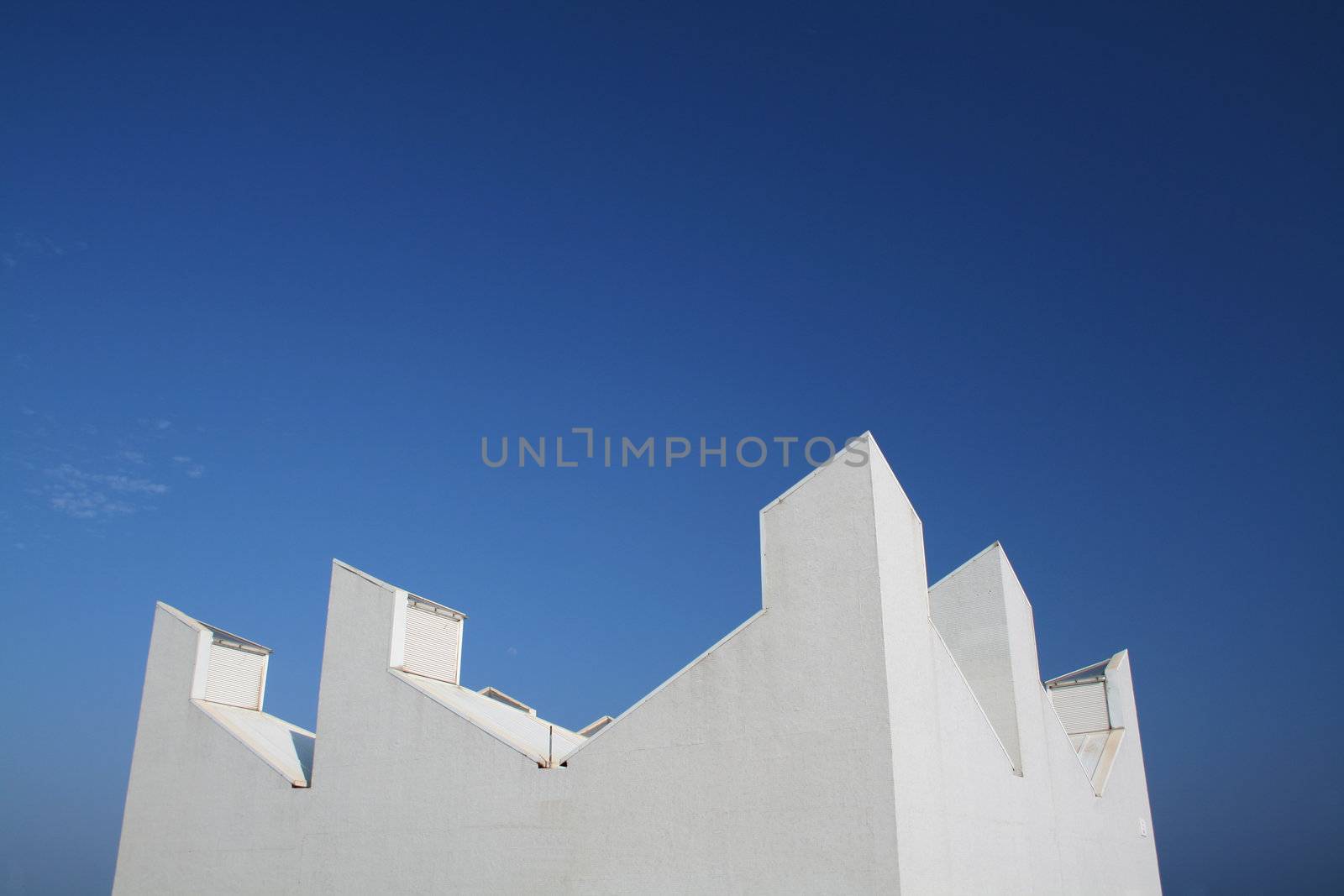 modern white building with a clean blue sky background

