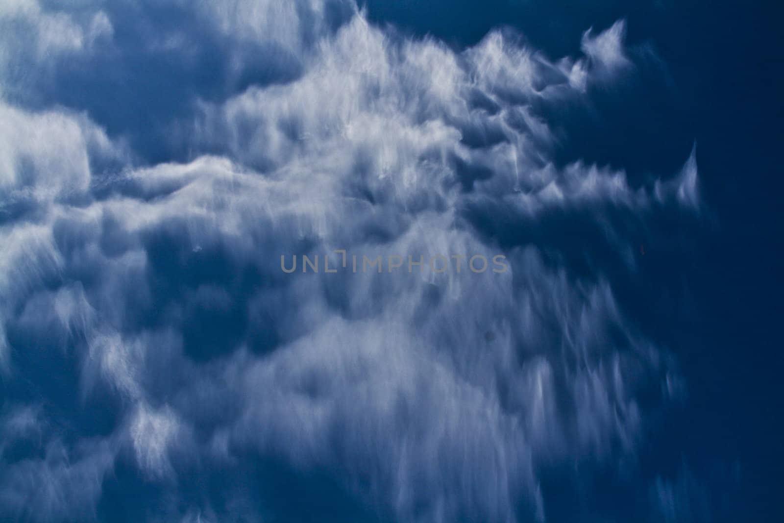 some clouds passing at a deep blue sky