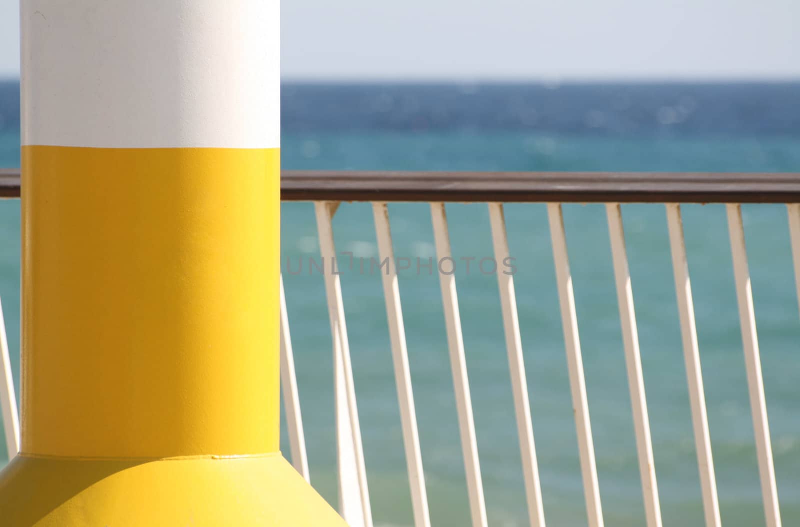 A bright yellow oceanographical signal at the beach on a summer sunny day.
