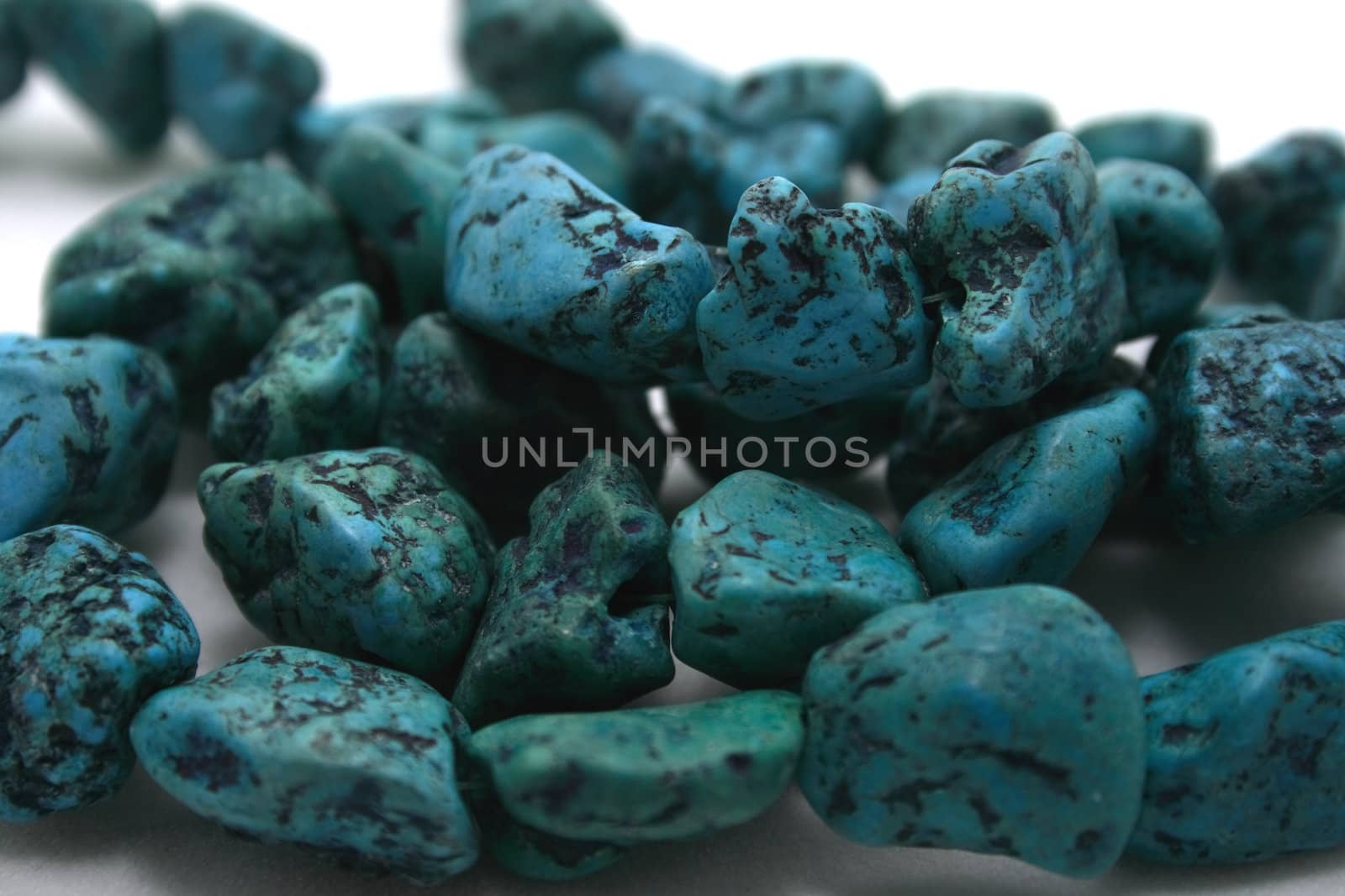 Turquoise stones on white background.