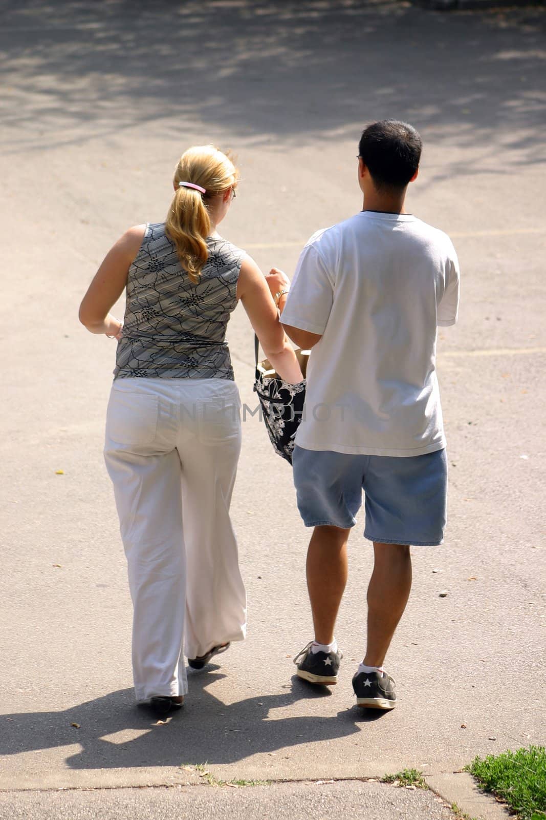 Couple walking away on a sunny day