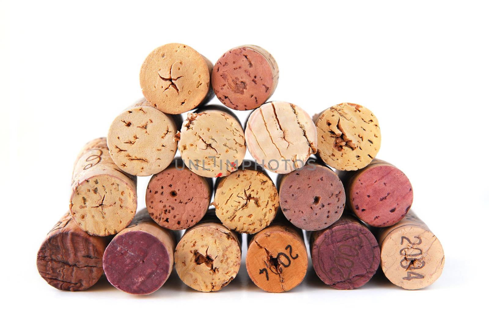 A pile of various wine corks on white background