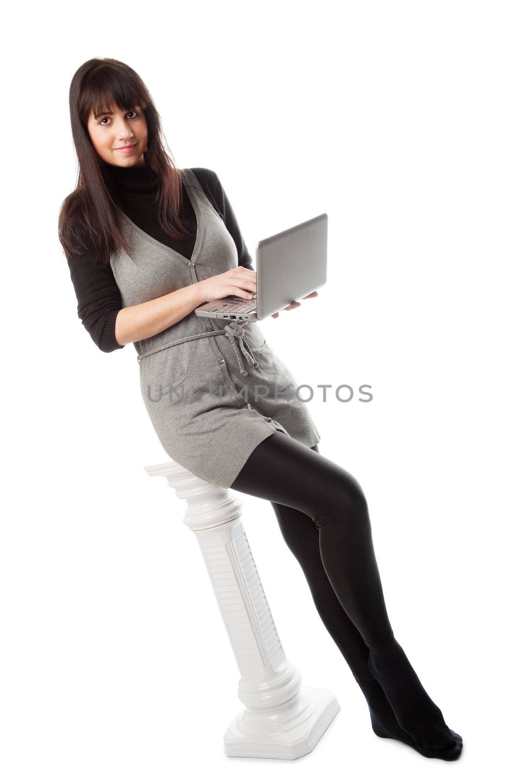 Pretty brunette girl with standing with netbook, isolated on white