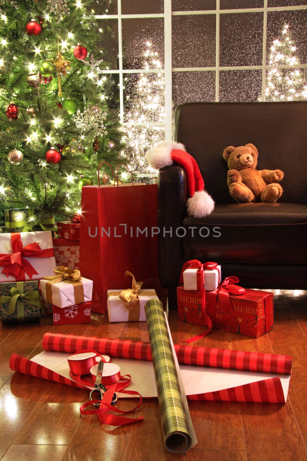 Christmas tree with gifts and teddy bear on chair