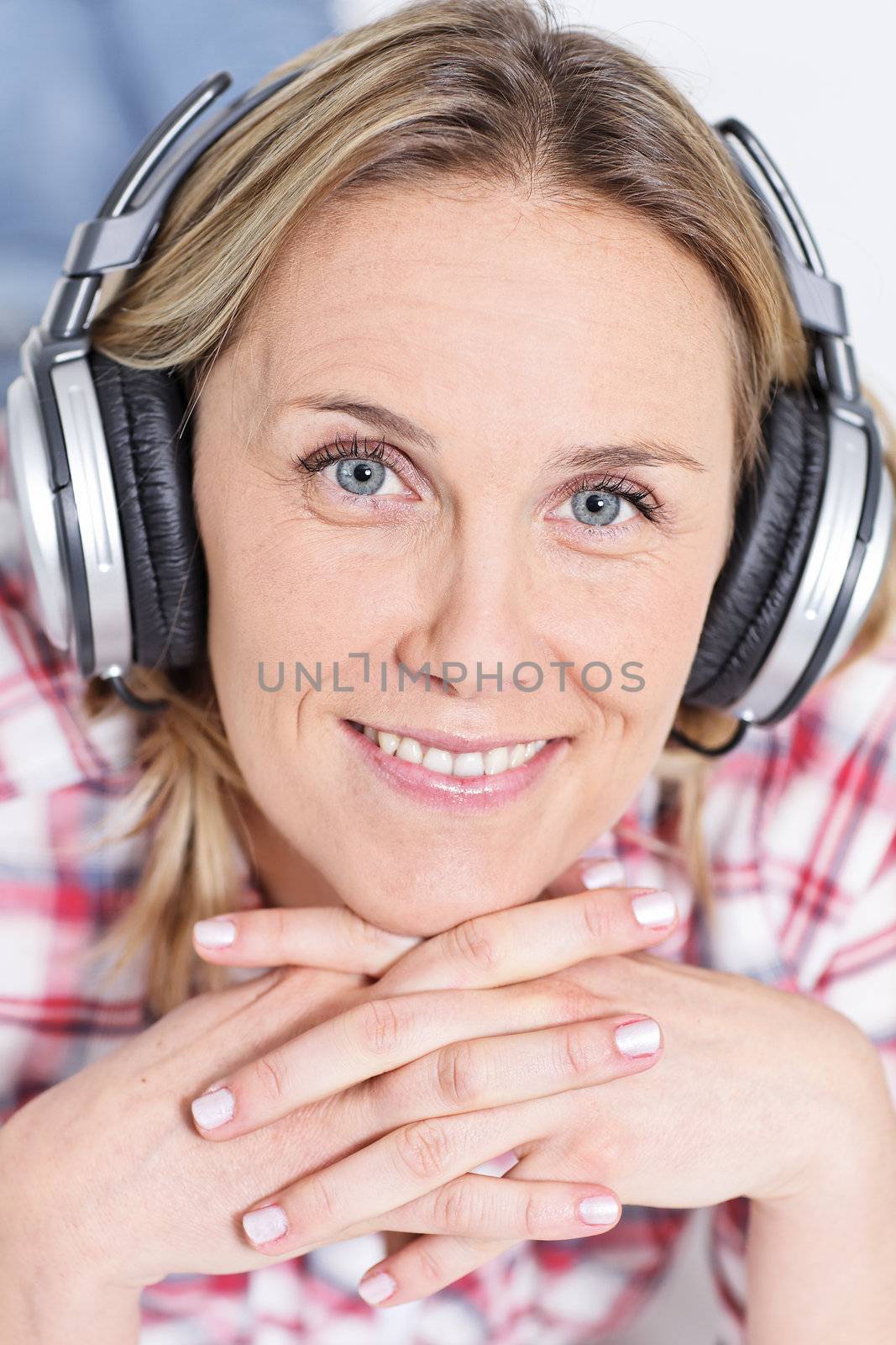 beautiful blond womanlistening music with headphones