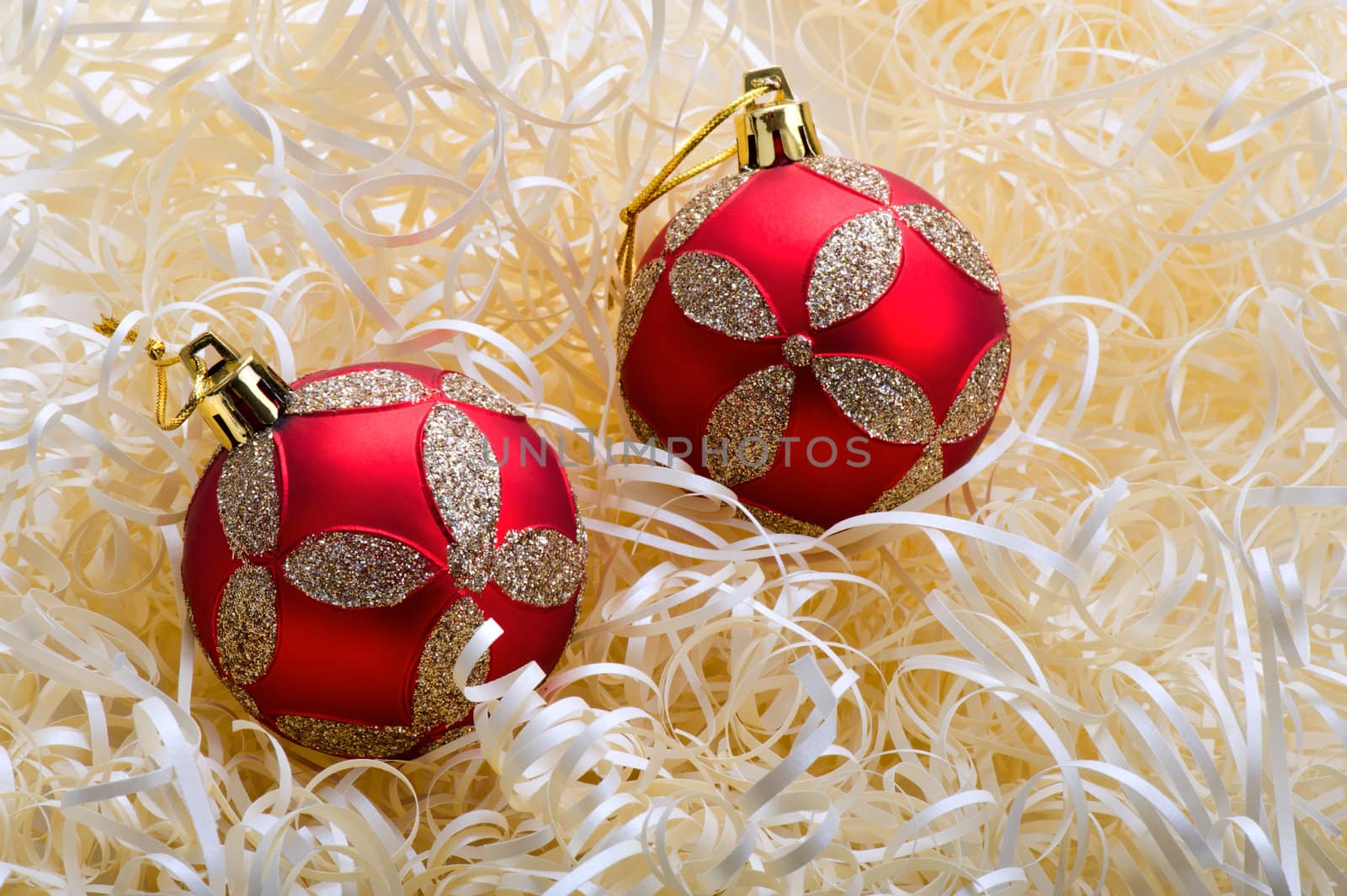 Two red christmas balls with yellow stripes