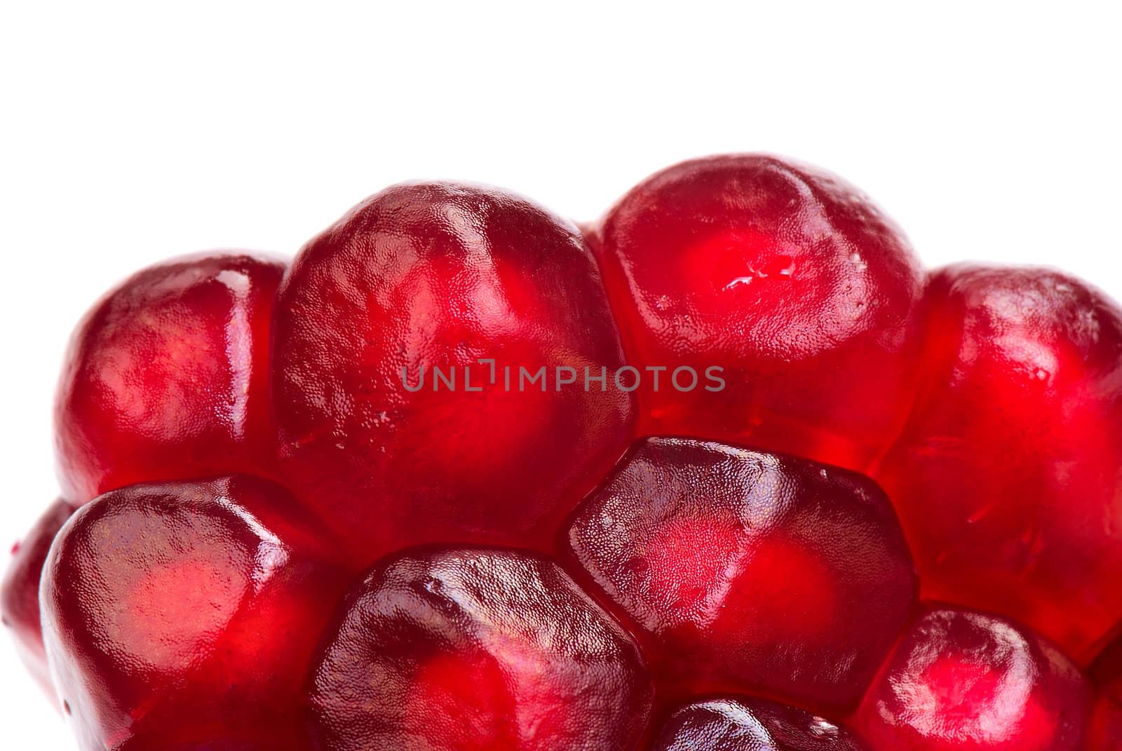 Pomegranate seeds on white background. Extreme close-up.