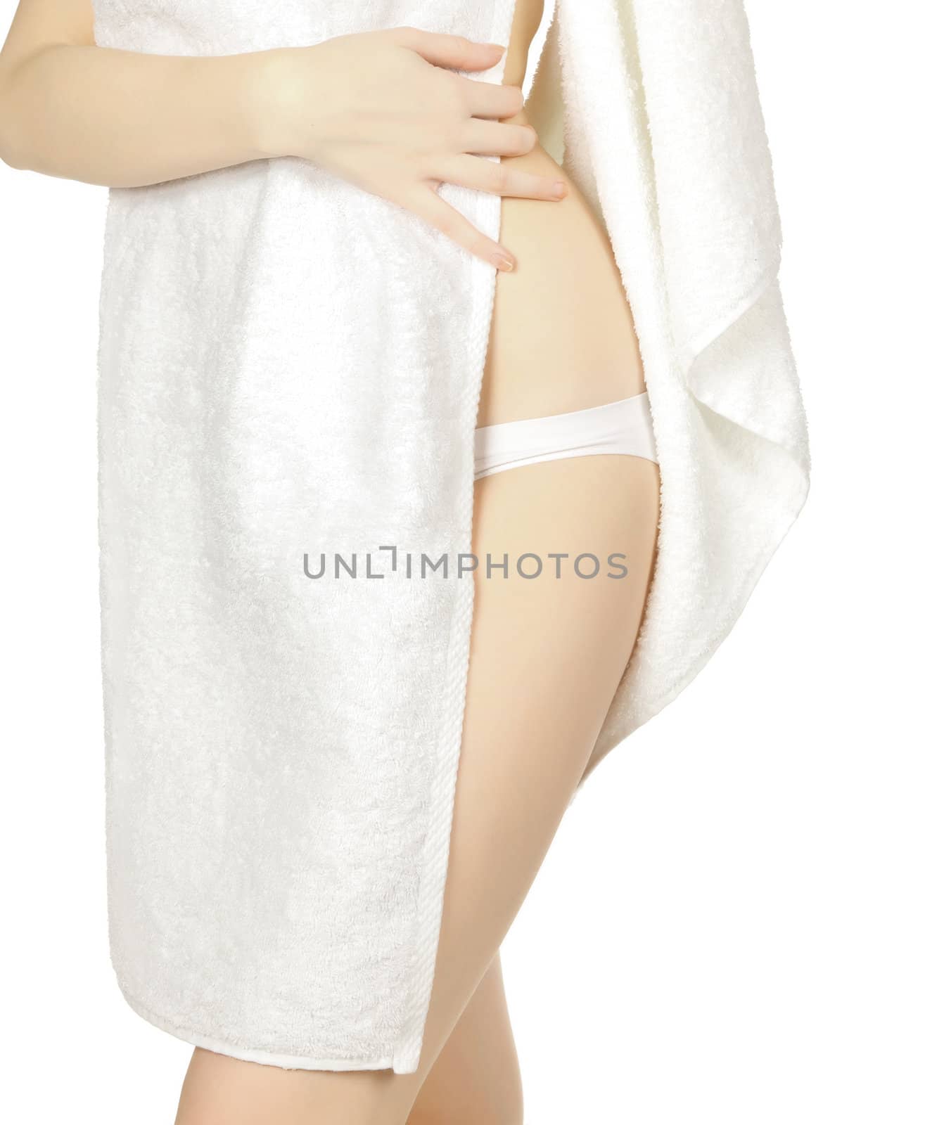 Woman wrapped in a towel posing on white background
