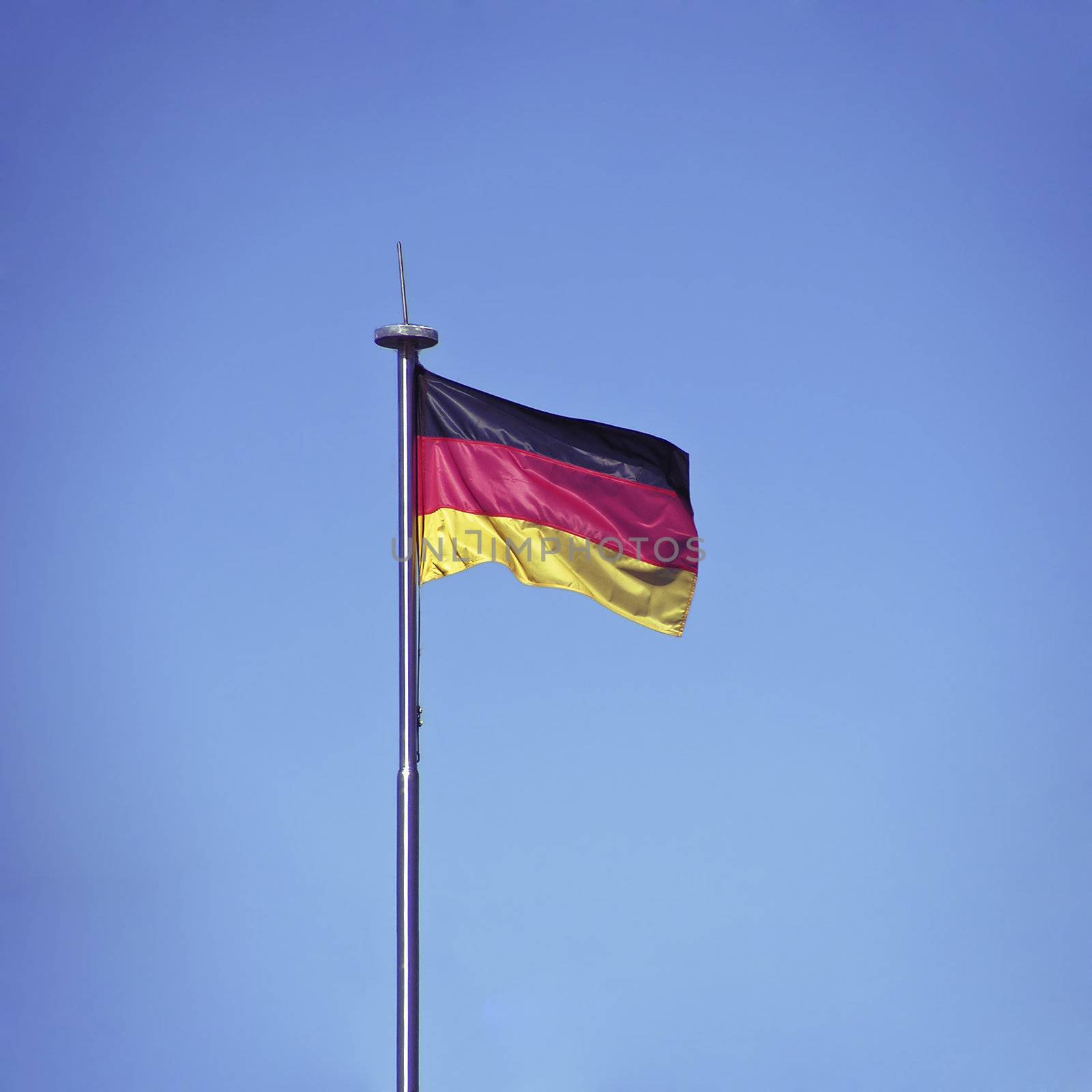 German flag on blue sky background