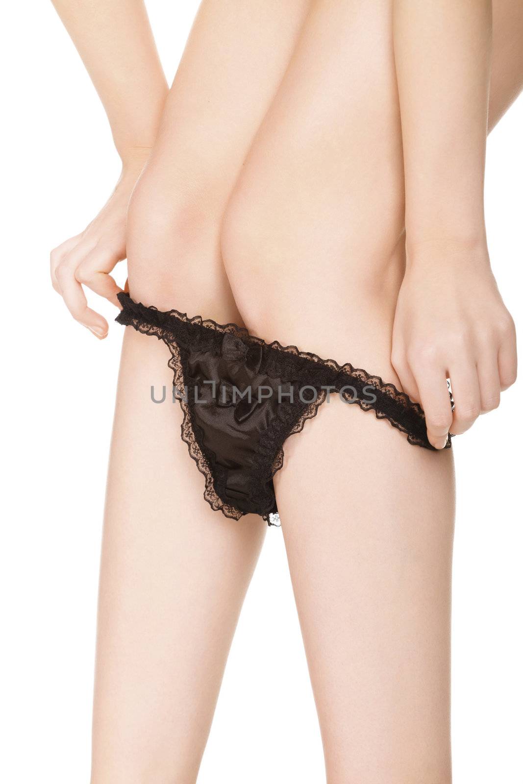 Woman takes off her panties, isolated on white background.