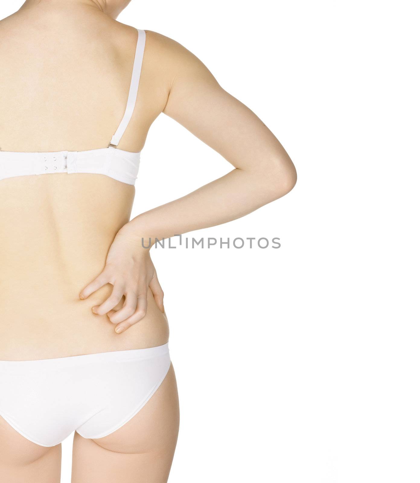 Slim woman massaging lower pain back, isolated on white background