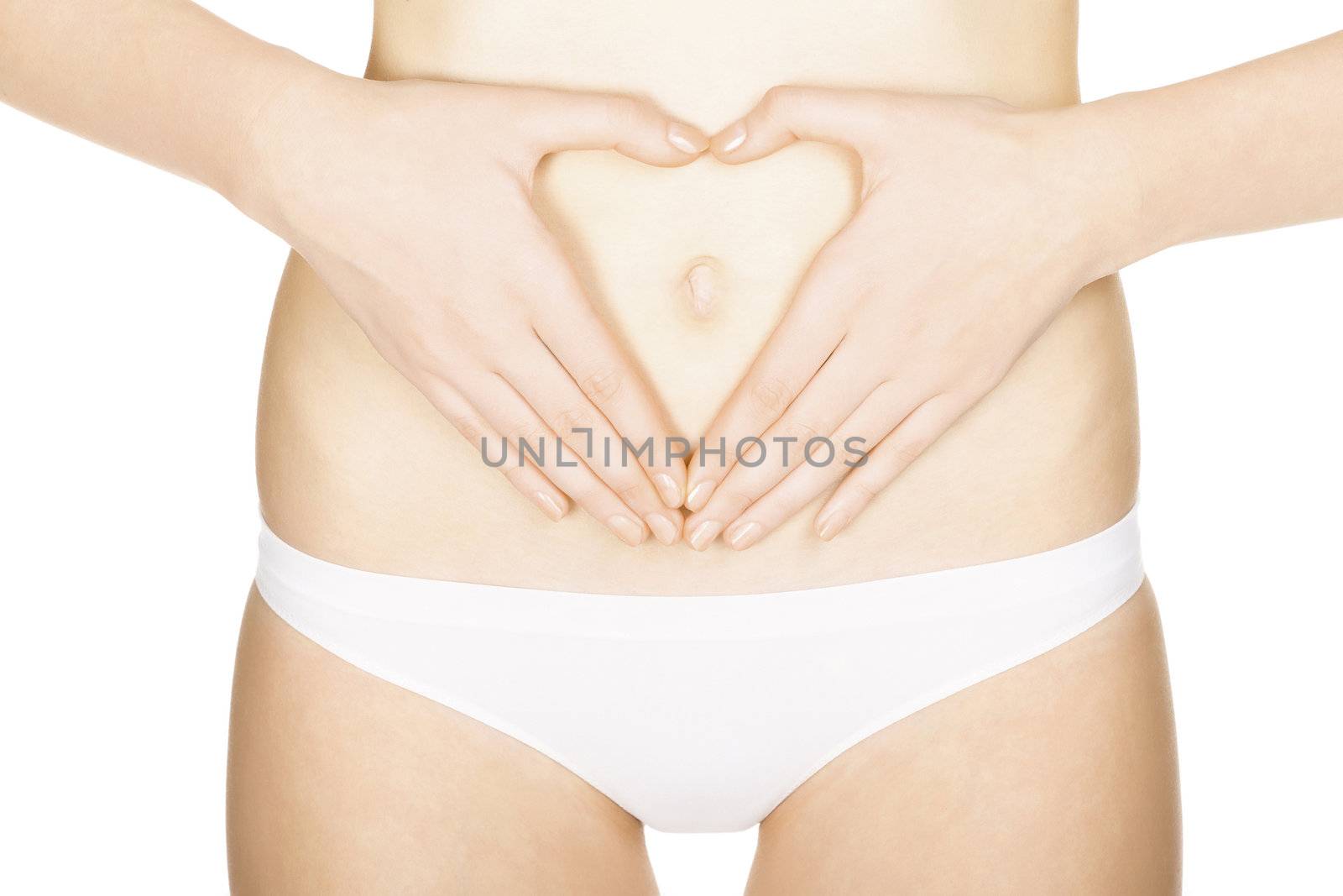 woman's hands forming a heart symbol on the belly