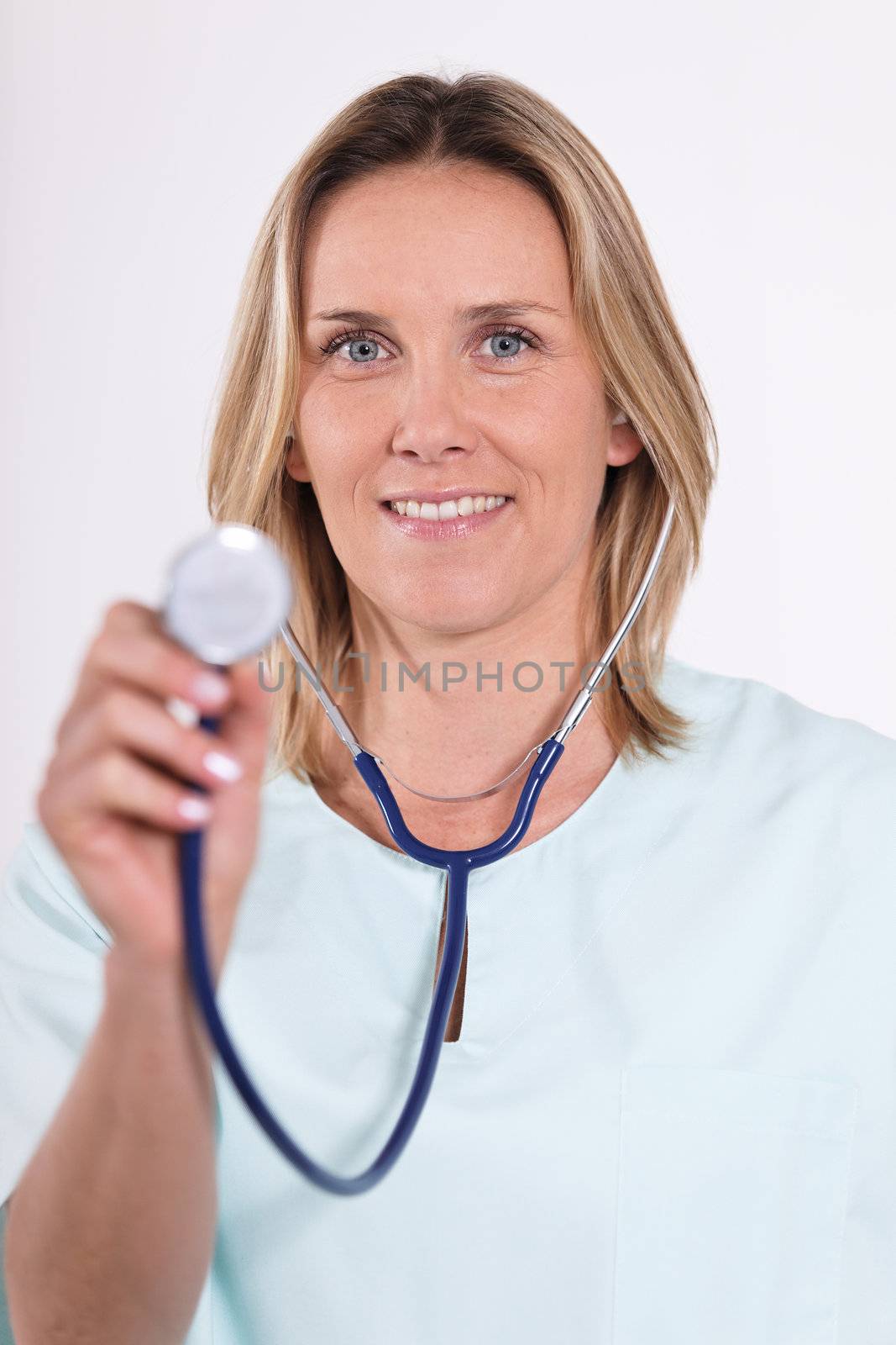 blond woman doctor with stethoscope in hospital