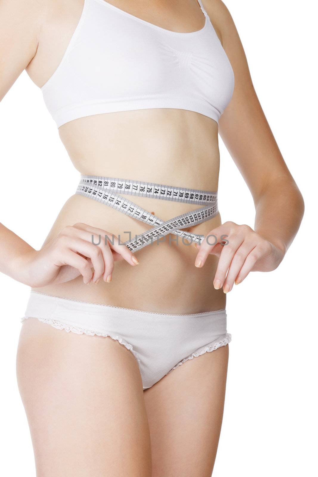 woman measuring size of her waist with a tape measure by Nobilior