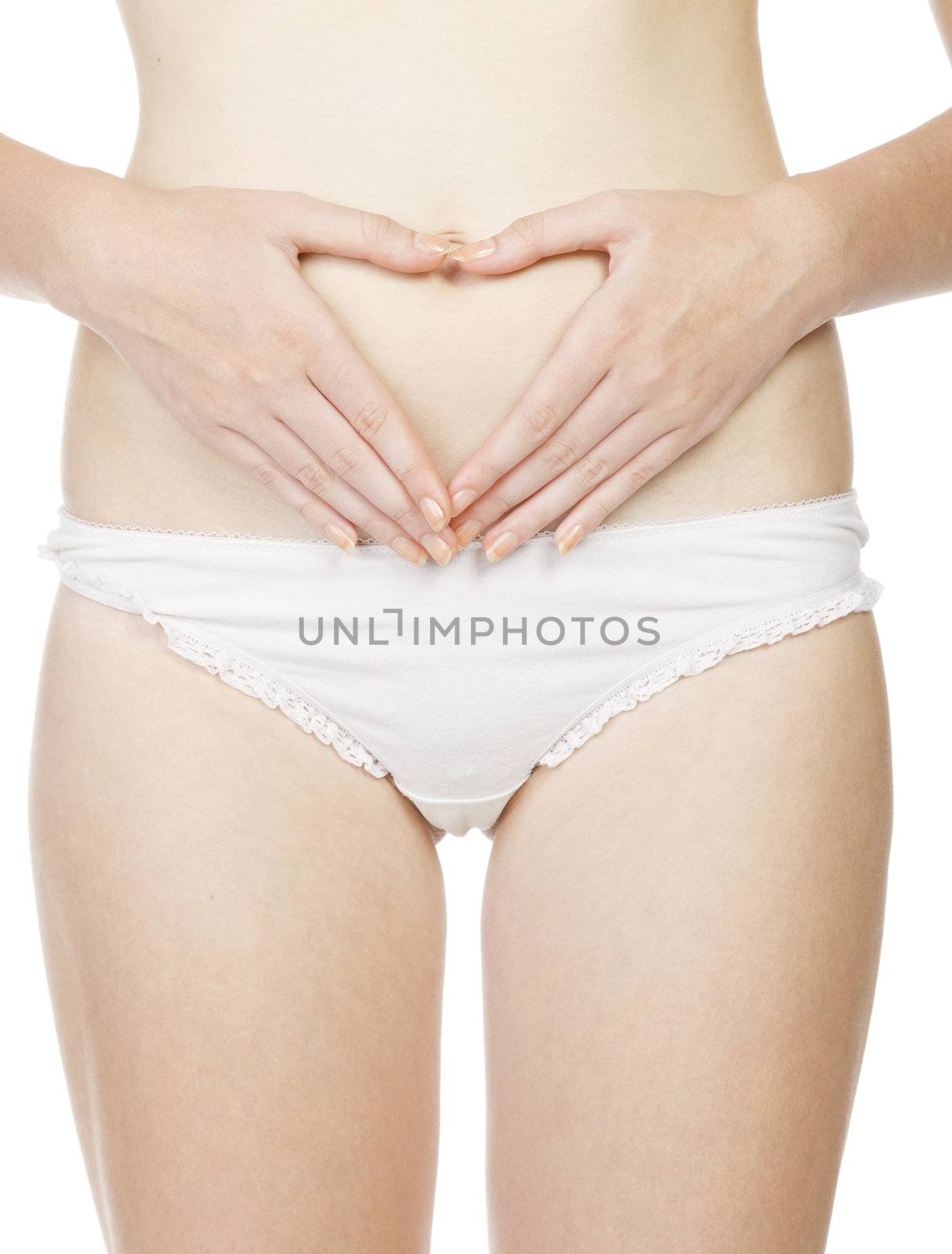 woman in white panties making heart shape with her hands on her belly, isolated on white background