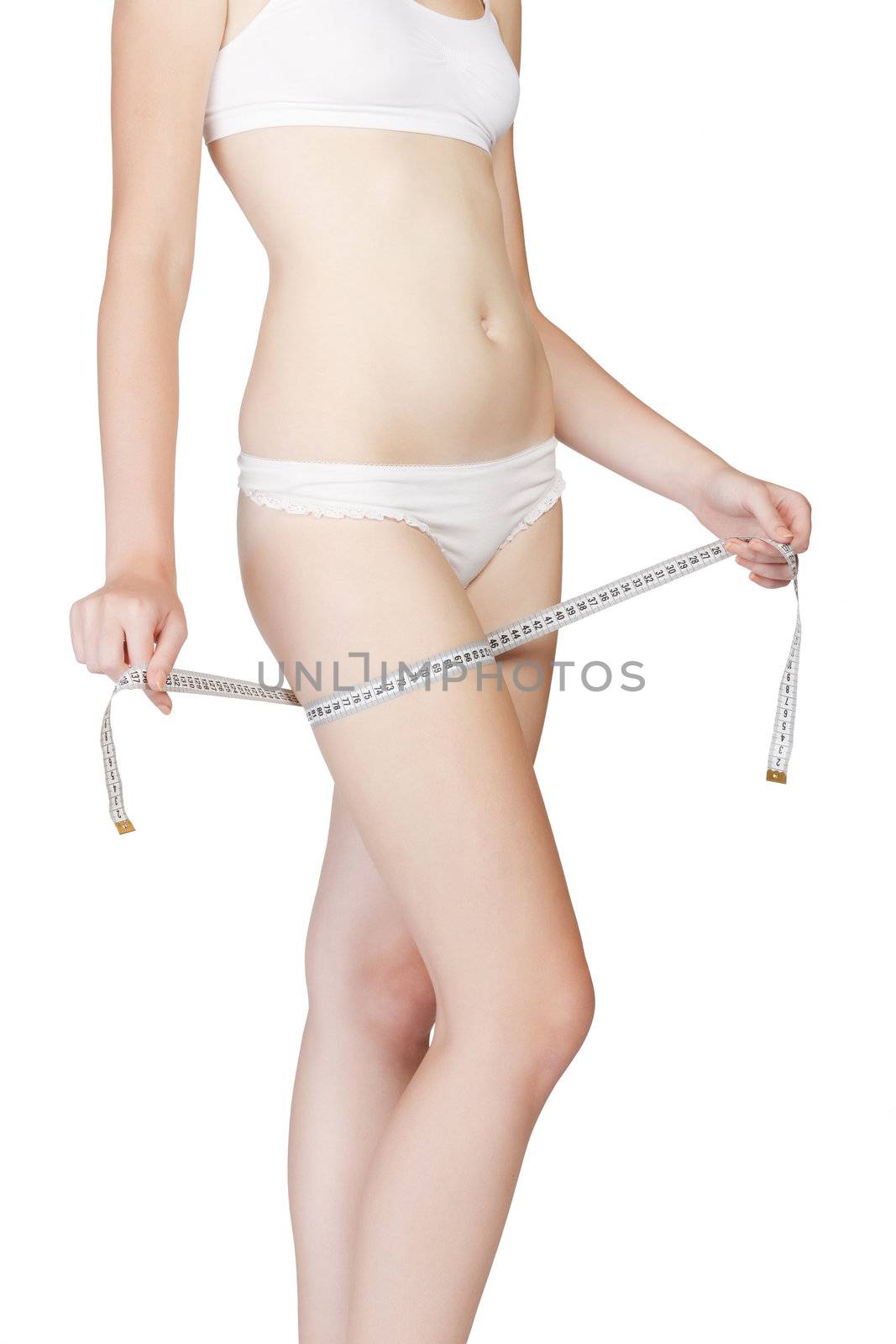 Woman measuring her thigh with a white metric tape. Isolated on white background