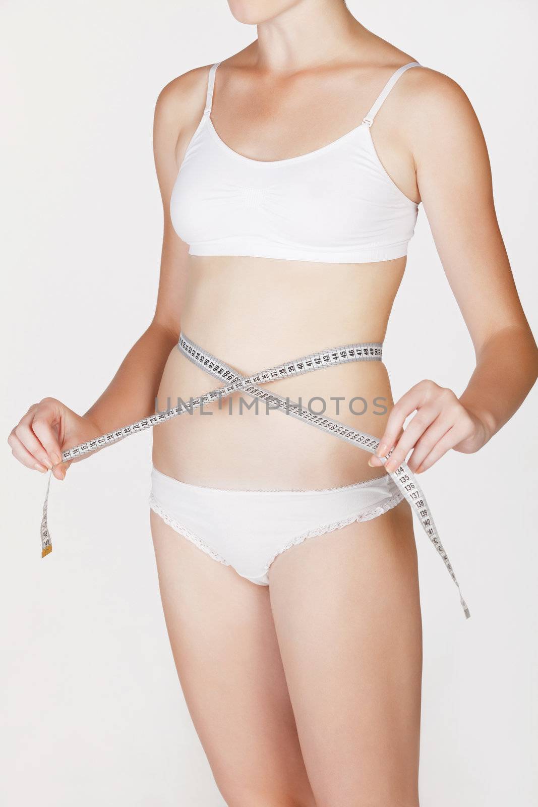 Woman measuring her waist by Nobilior
