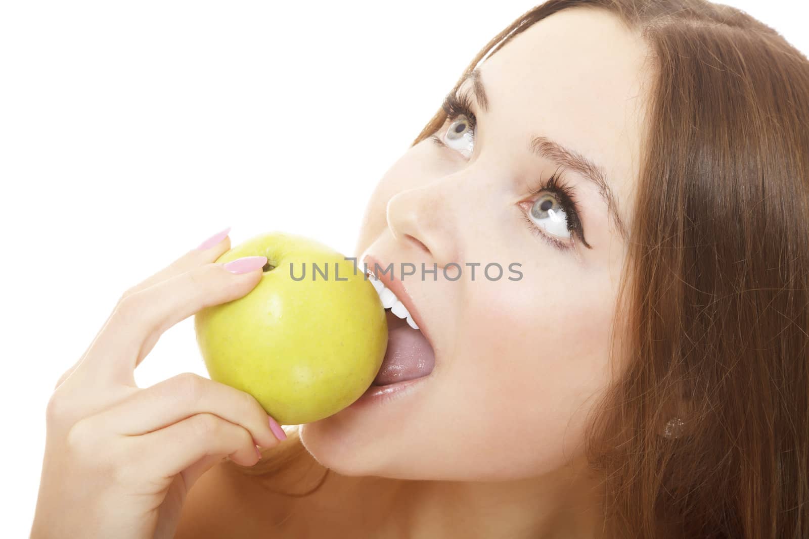 Pretty girl with open mouth eating green ripe apple, isolated over white background